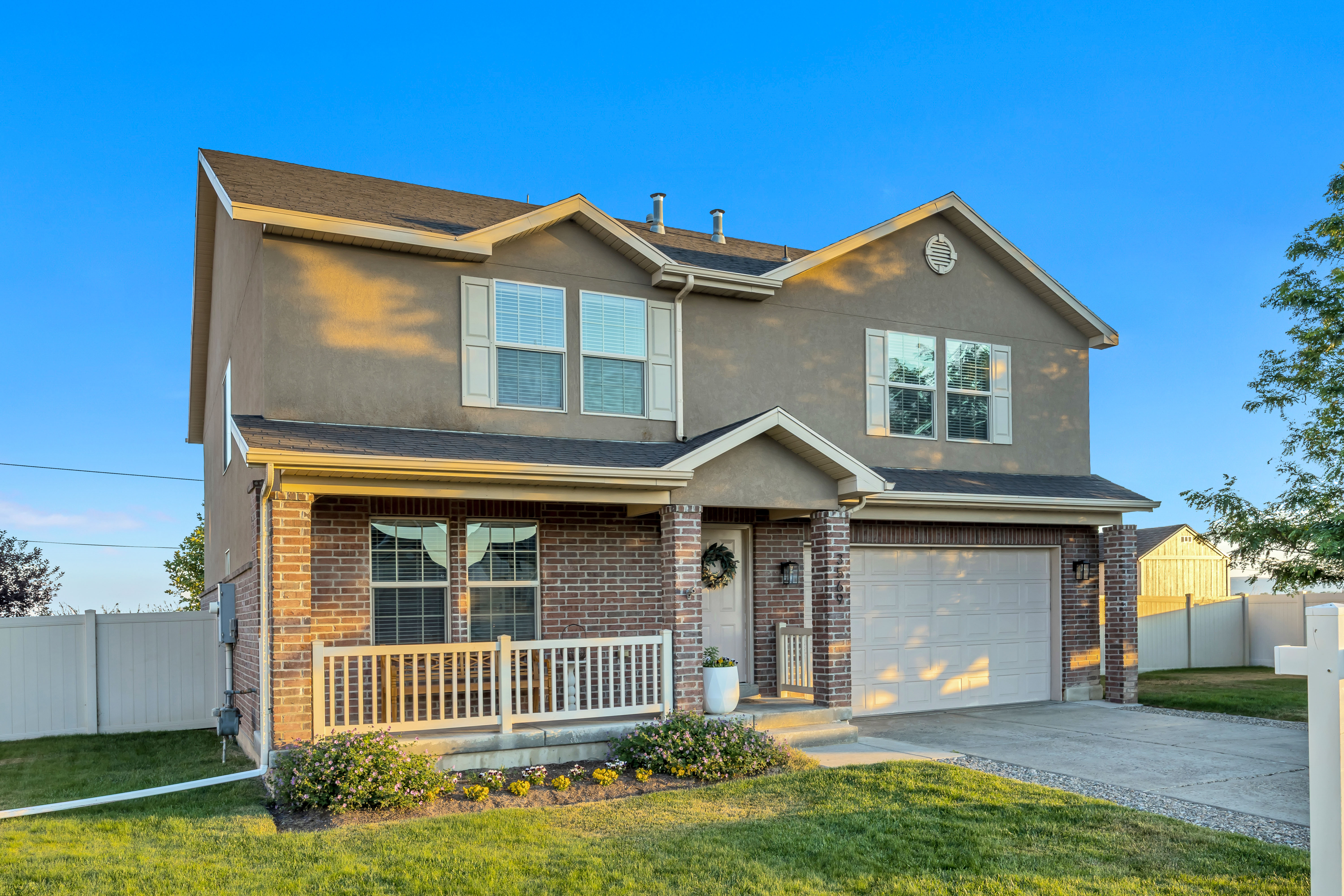 Two-story home featuring a combination of brick and stucco siding