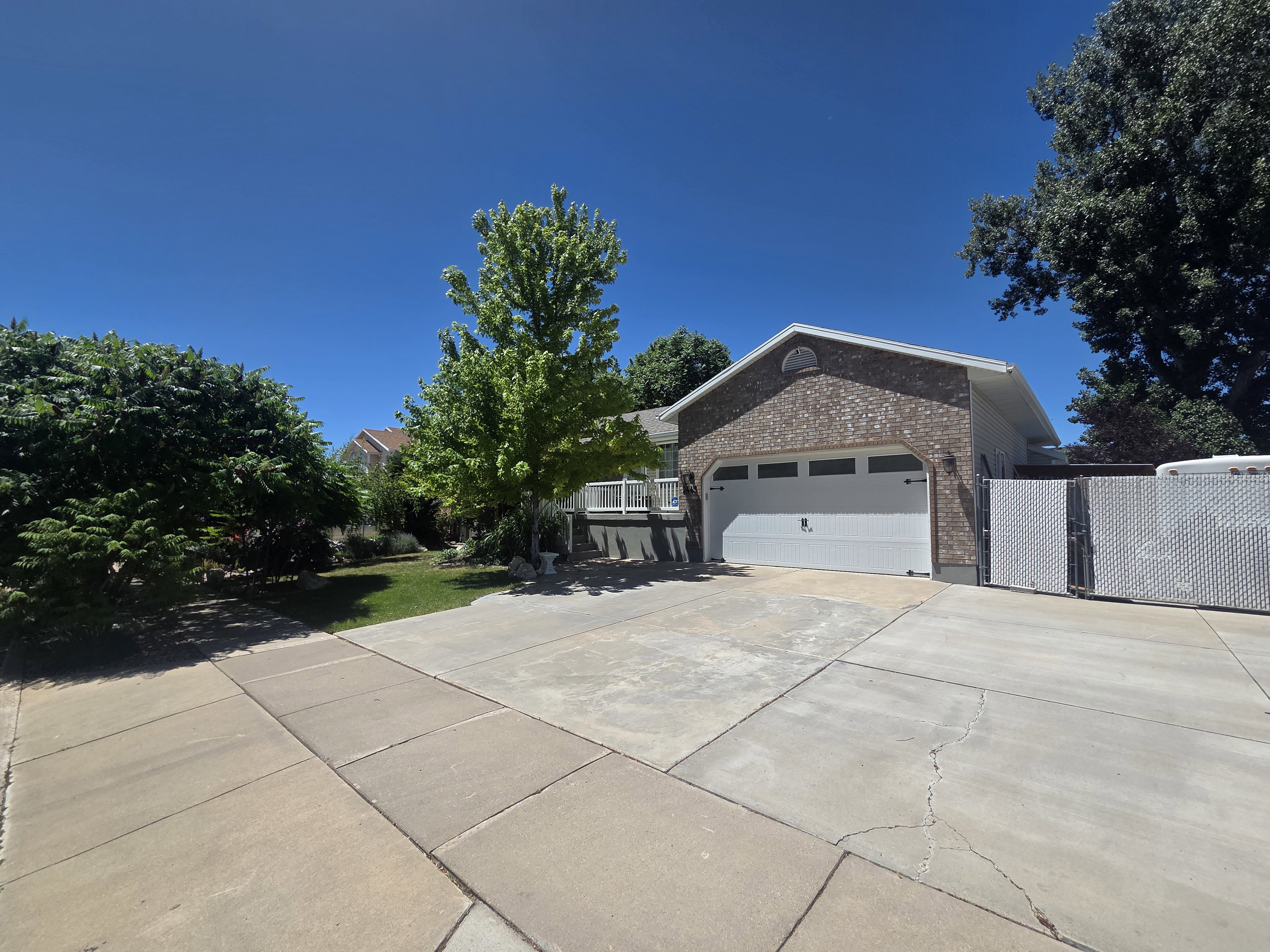 Brick-clad exterior featuring a two-car garage with a white overhead door
