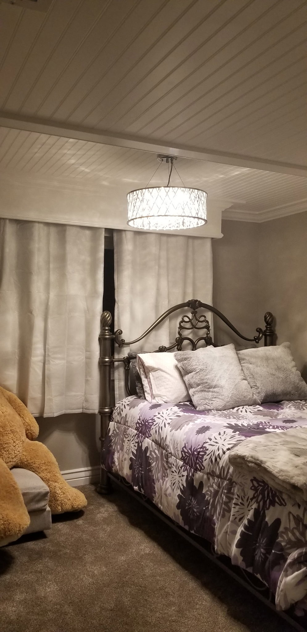Bedroom featuring a metal bed frame, plush carpeting, and a beadboard ceiling
