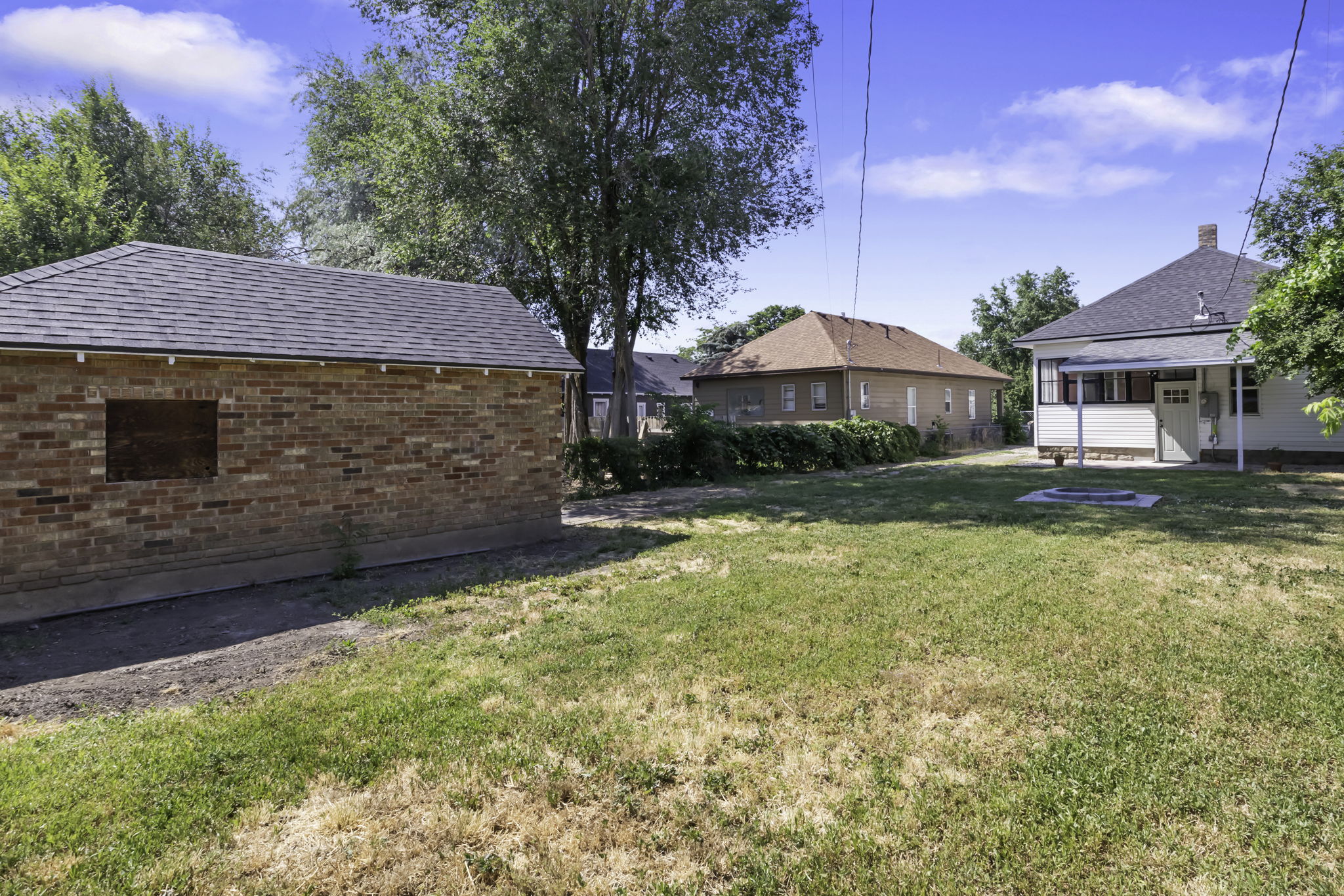 Brick outbuilding with shingled roof