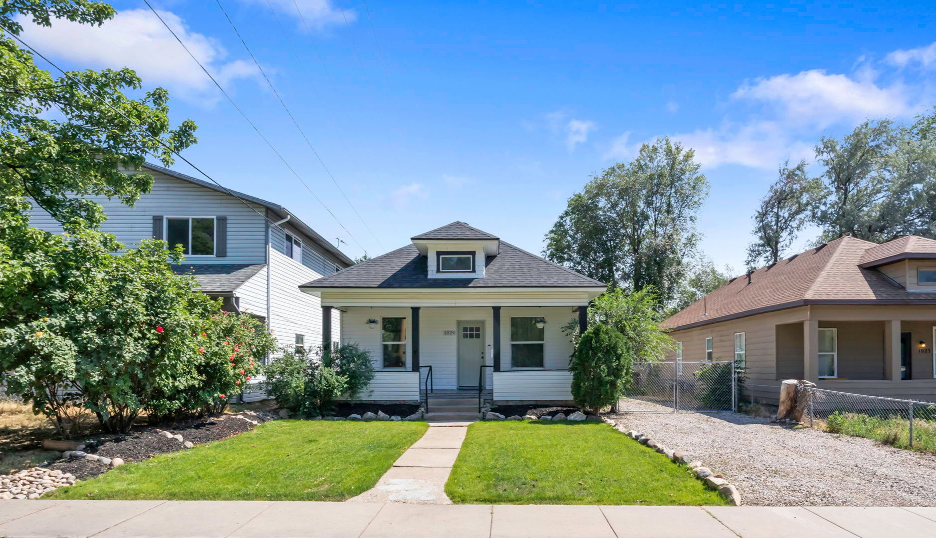 White exterior with black trim and a dark shingle roof