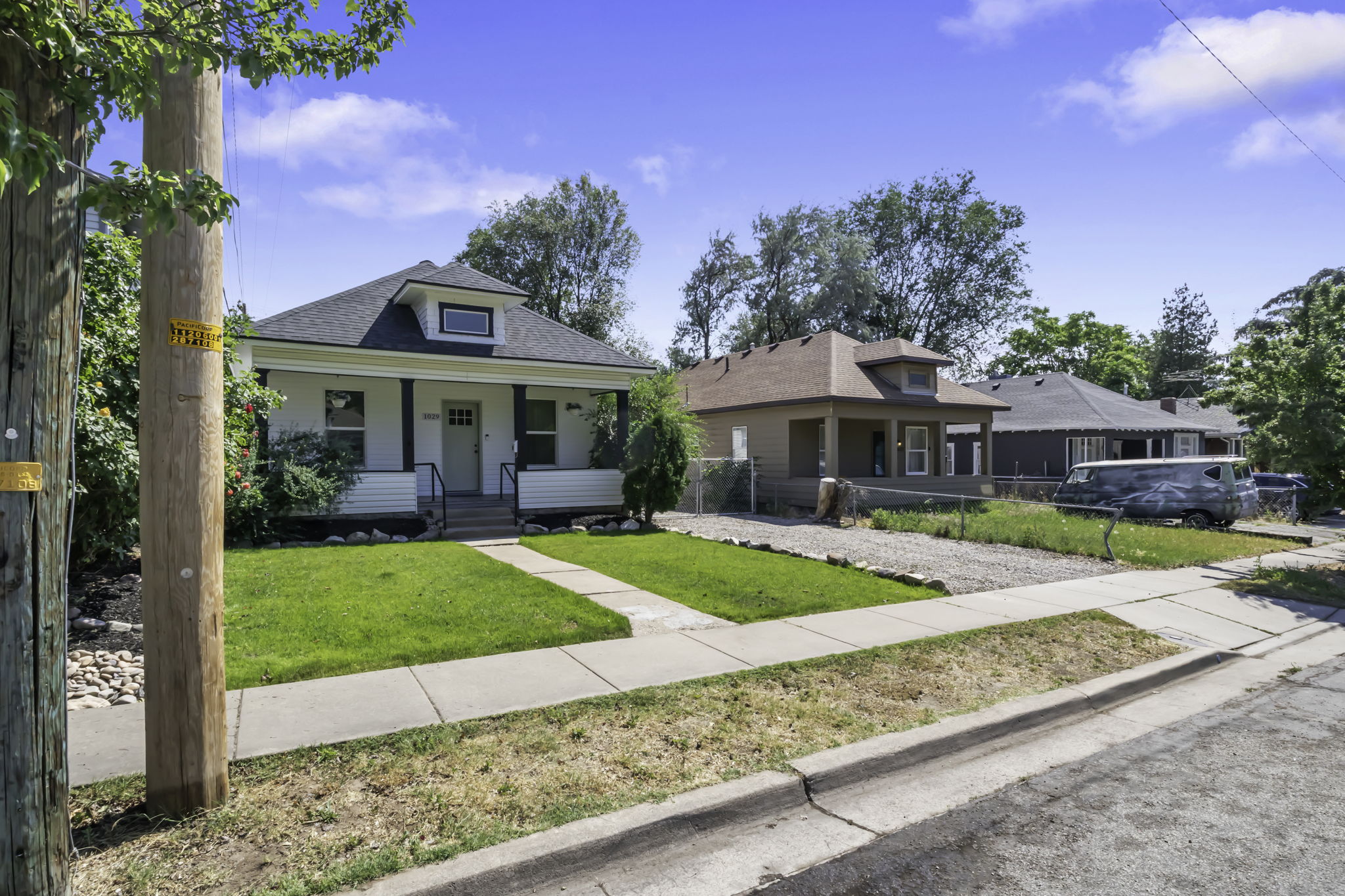 Single-story residence featuring a covered front porch with white railings and dark support pillars