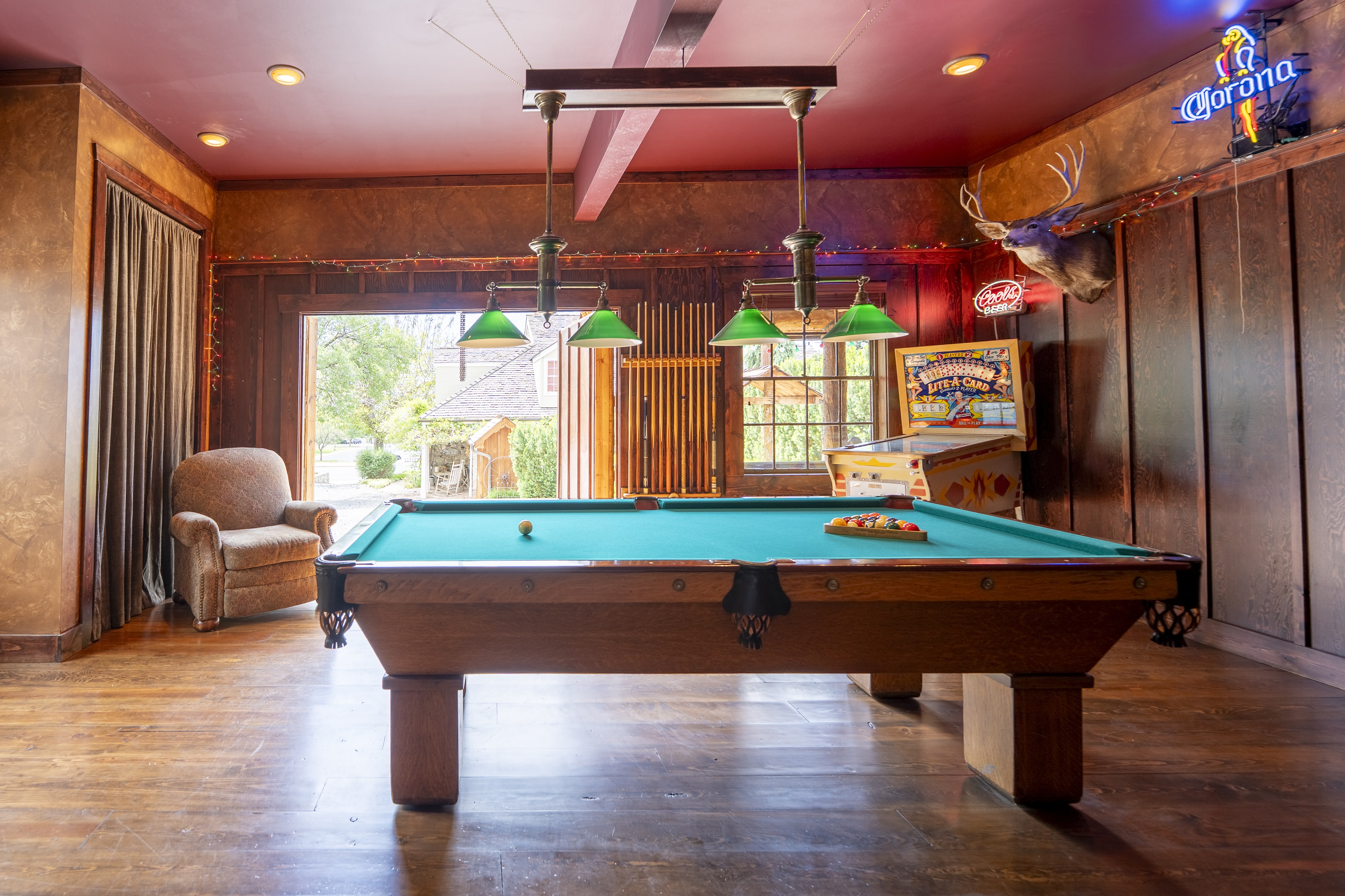 Garage/Game room featuring wood-finish flooring, recessed lighting, and a suspended billiard light fixture
