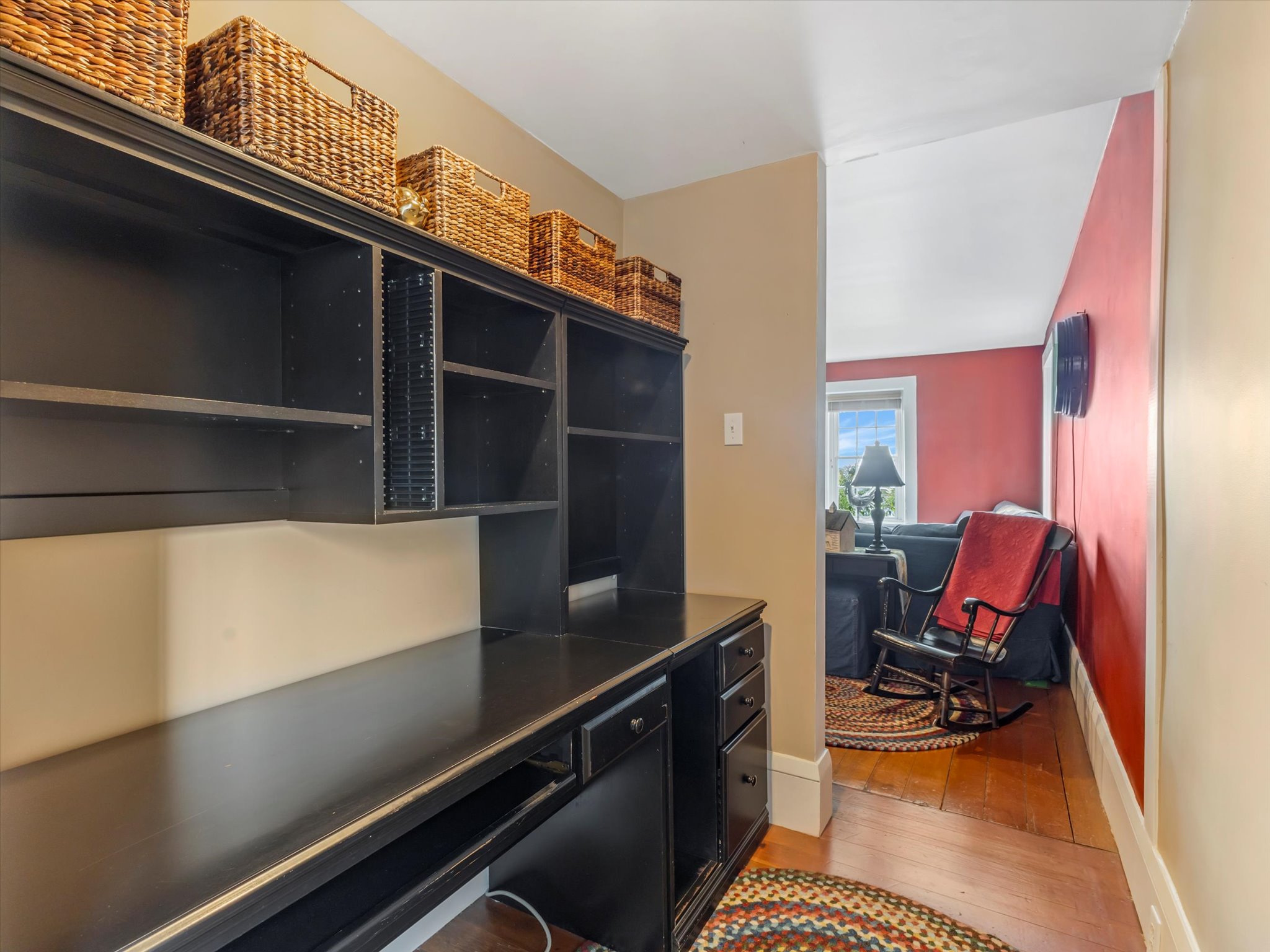 Built-in black cabinetry with integrated shelving and desk workspace