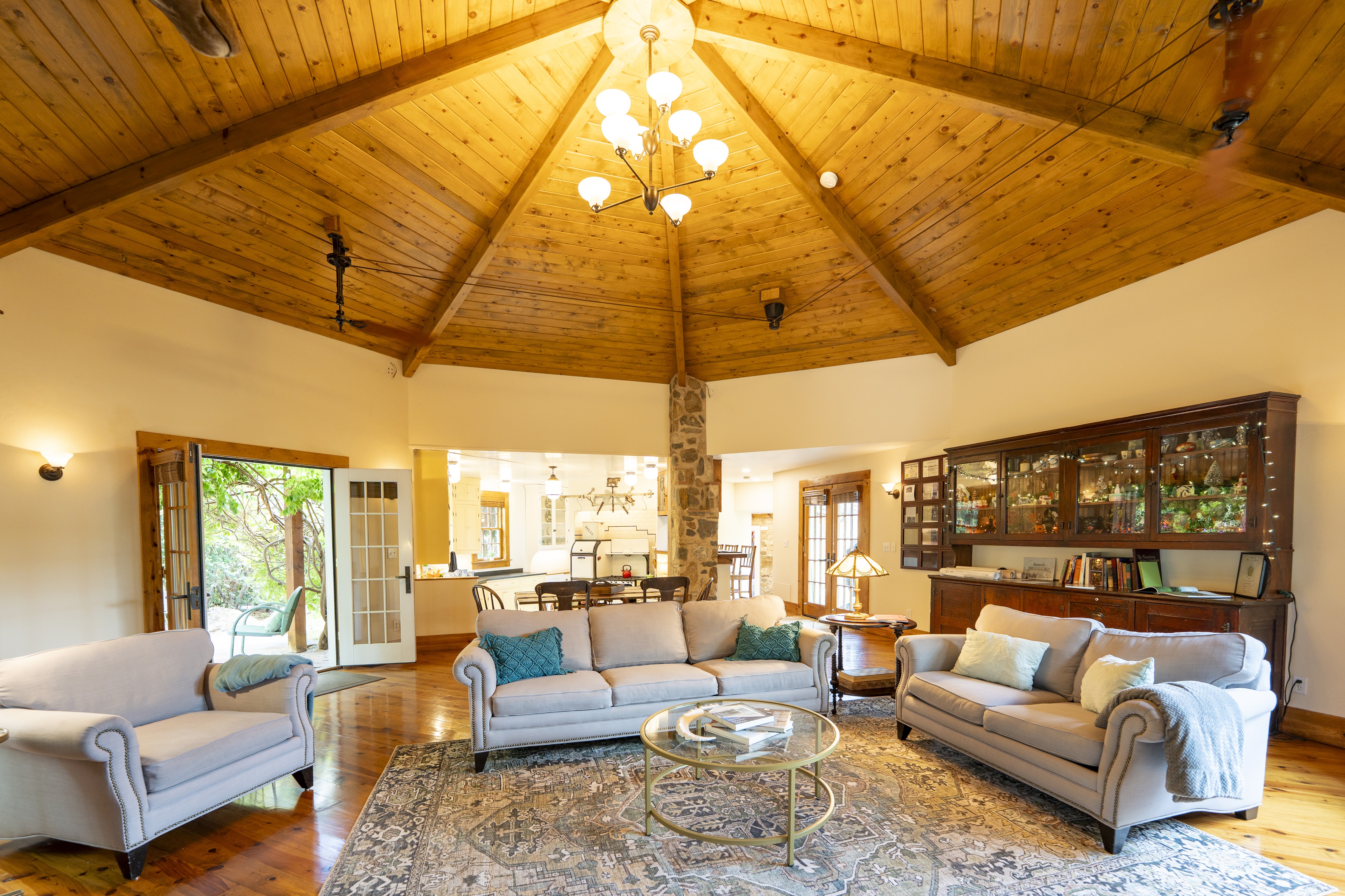 Vaulted wood-finish ceiling with exposed beams and recessed lighting
