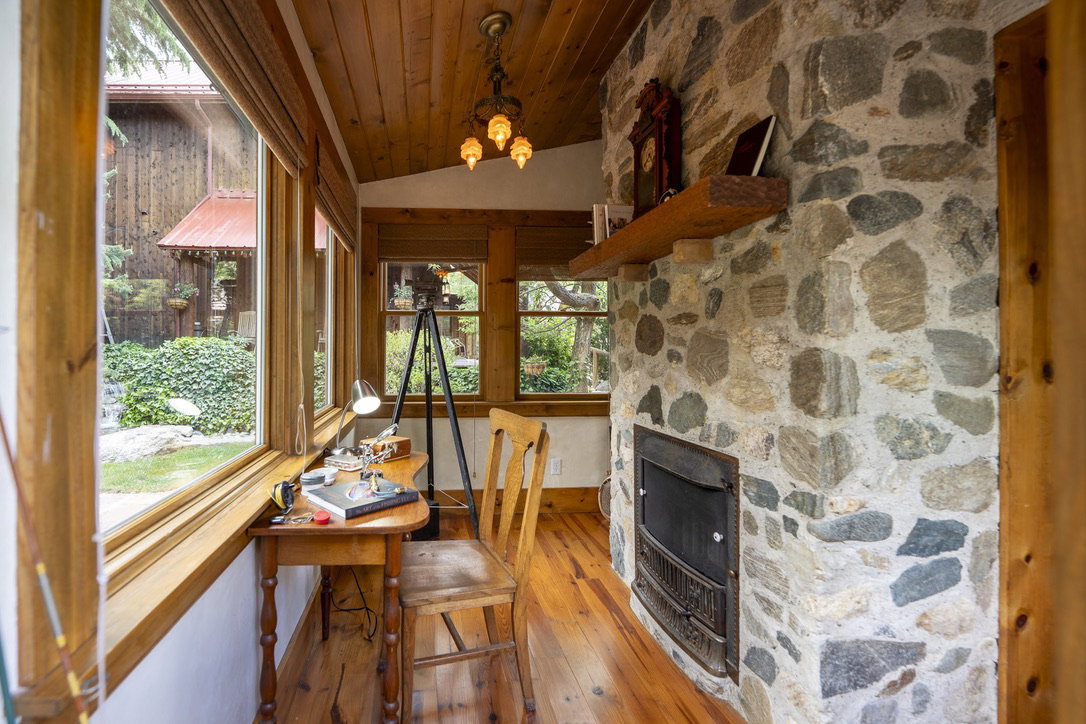 Stone-faced fireplace with a wood mantel and metal insert