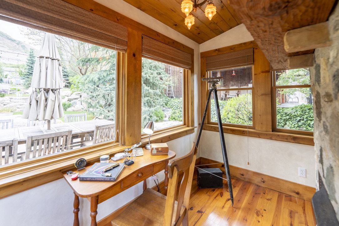 Wood-paneled ceiling with an exposed beam and a multi-light fixture