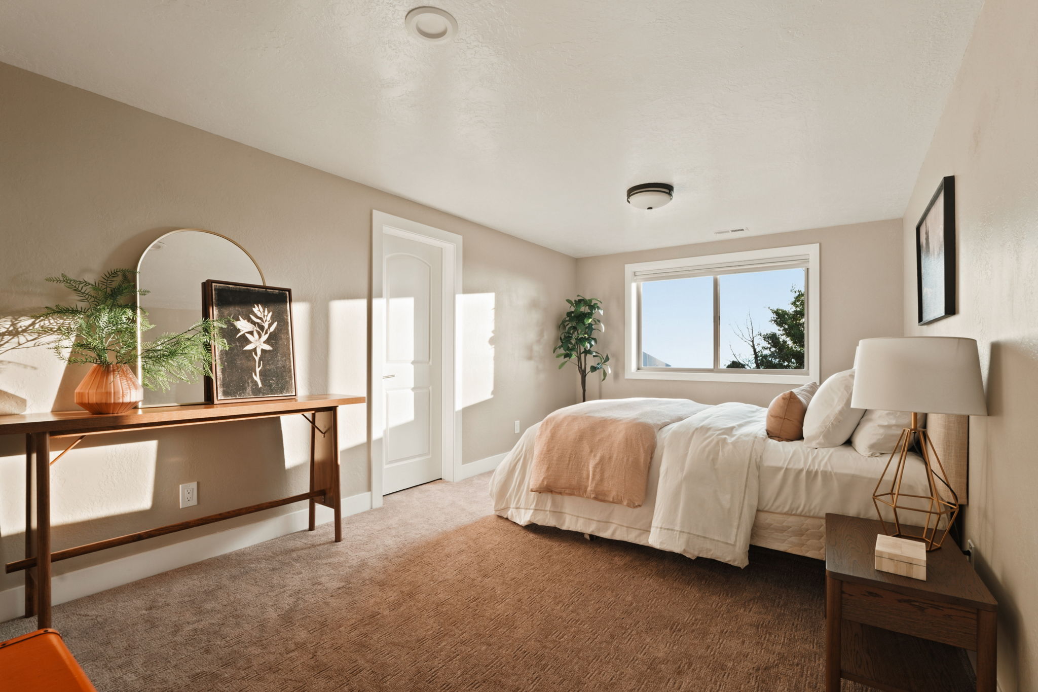 Bedroom featuring plush carpet flooring, a large window, a ceiling-mounted light fixture, and a recessed ceiling light