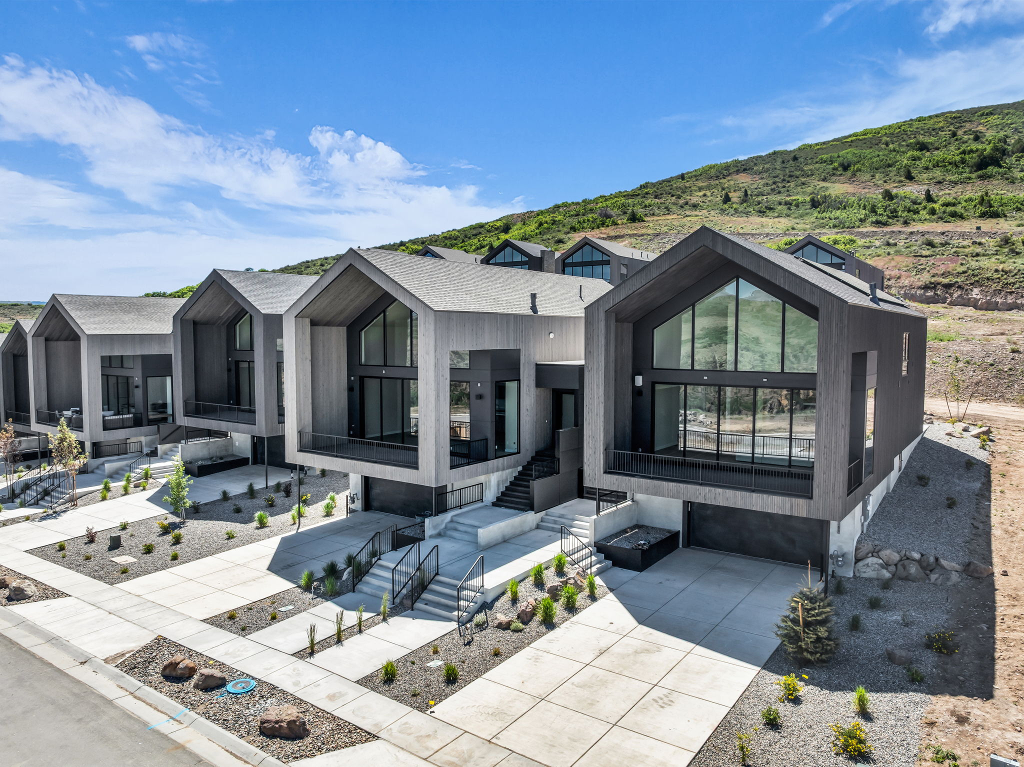 Modern architectural design with a gabled roofline and extensive window placement