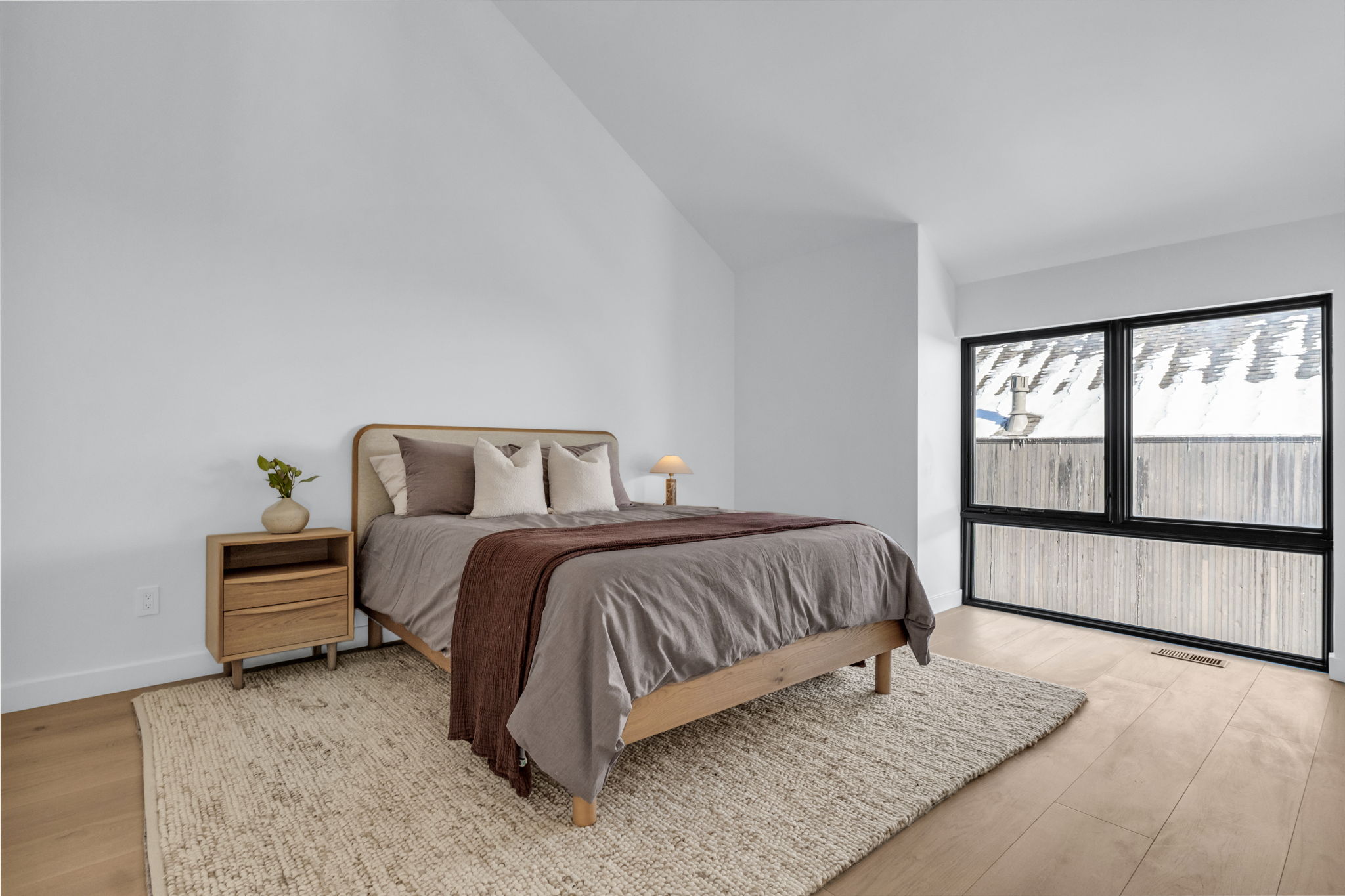 Vaulted ceilings enhance the bright interior featuring light wood-finish flooring
