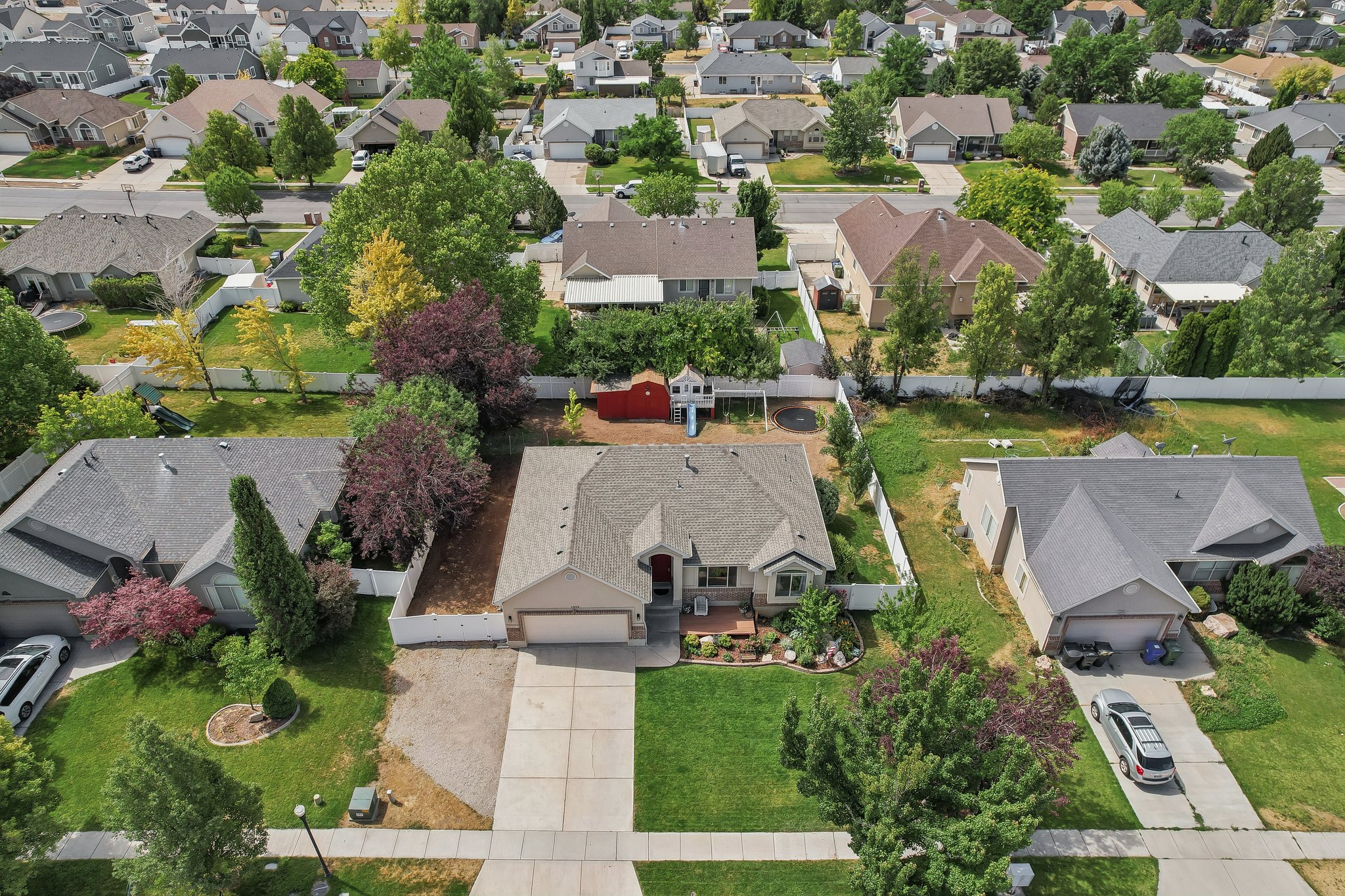 Traditional-style residence featuring a gray shingle roof, a two-car garage, and a concrete driveway