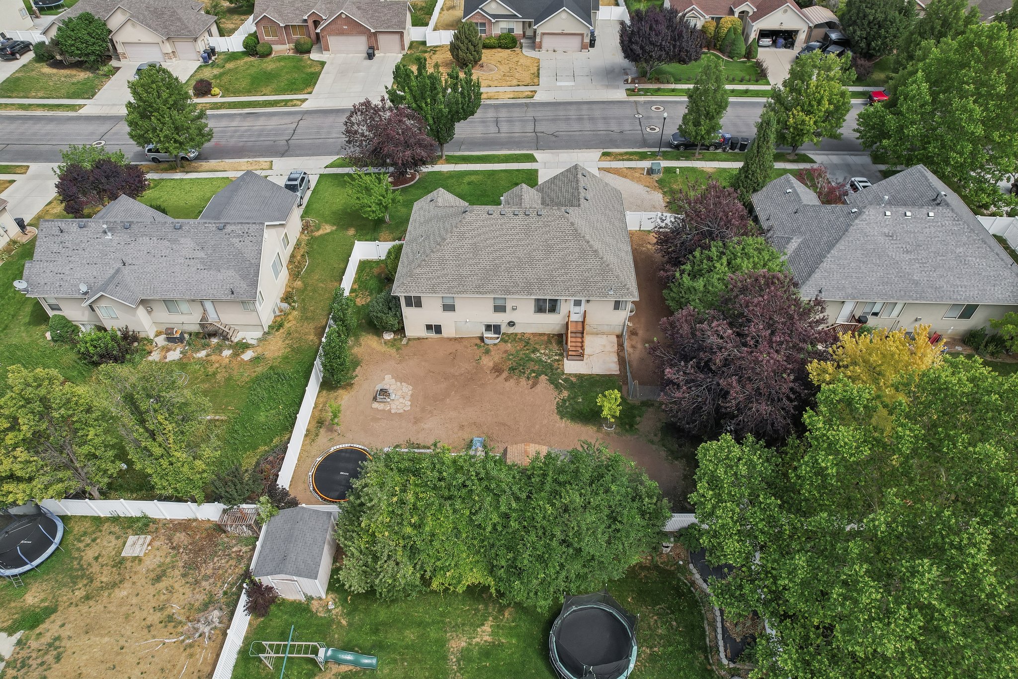 Aerial perspective highlighting the property with a grey shingle roof