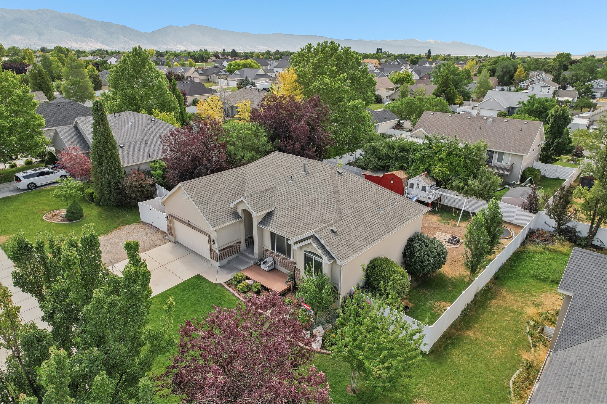 Single-story residence featuring a neutral-toned exterior, an attached two-car garage, and a covered front entry