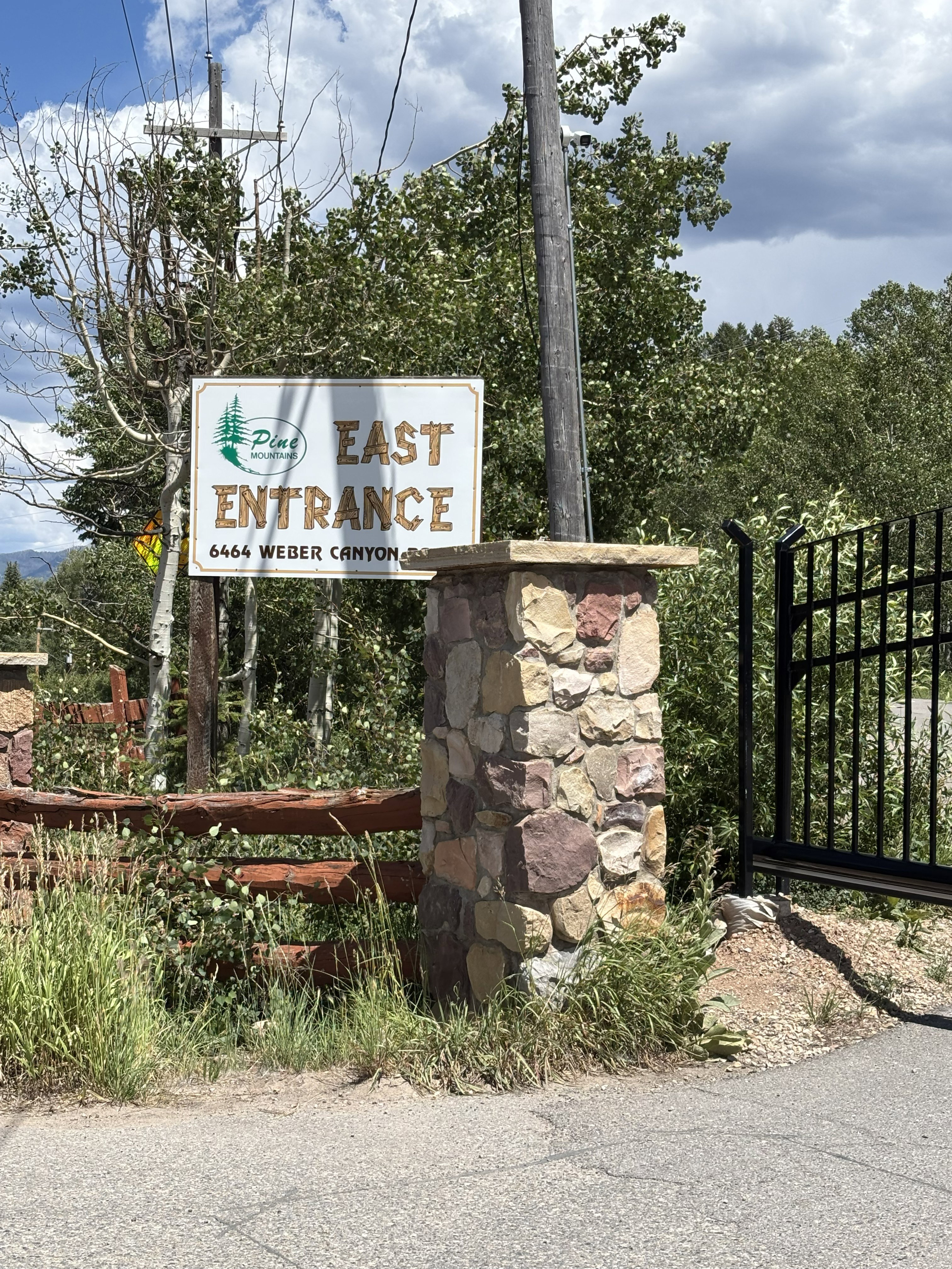 Stone column entrance featuring a new electronic gate