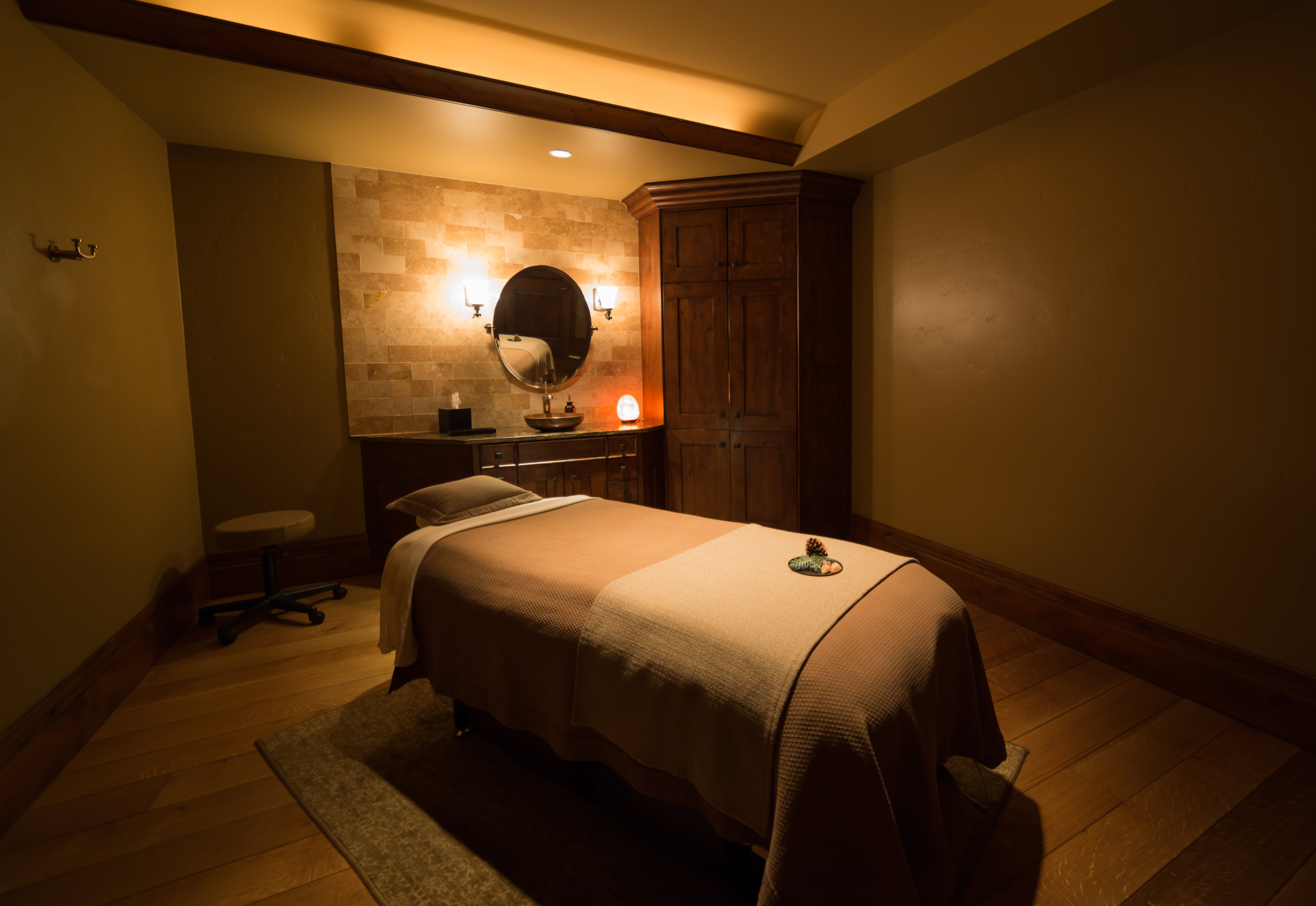 Interior space featuring a stacked stone accent wall, wood-finish flooring, and a built-in wooden cabinet