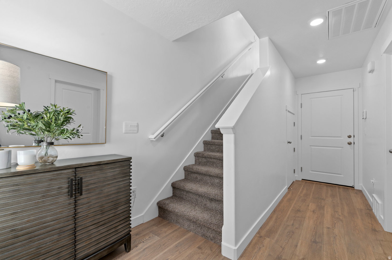 Laminate wood-finish flooring provides a durable surface throughout the entry