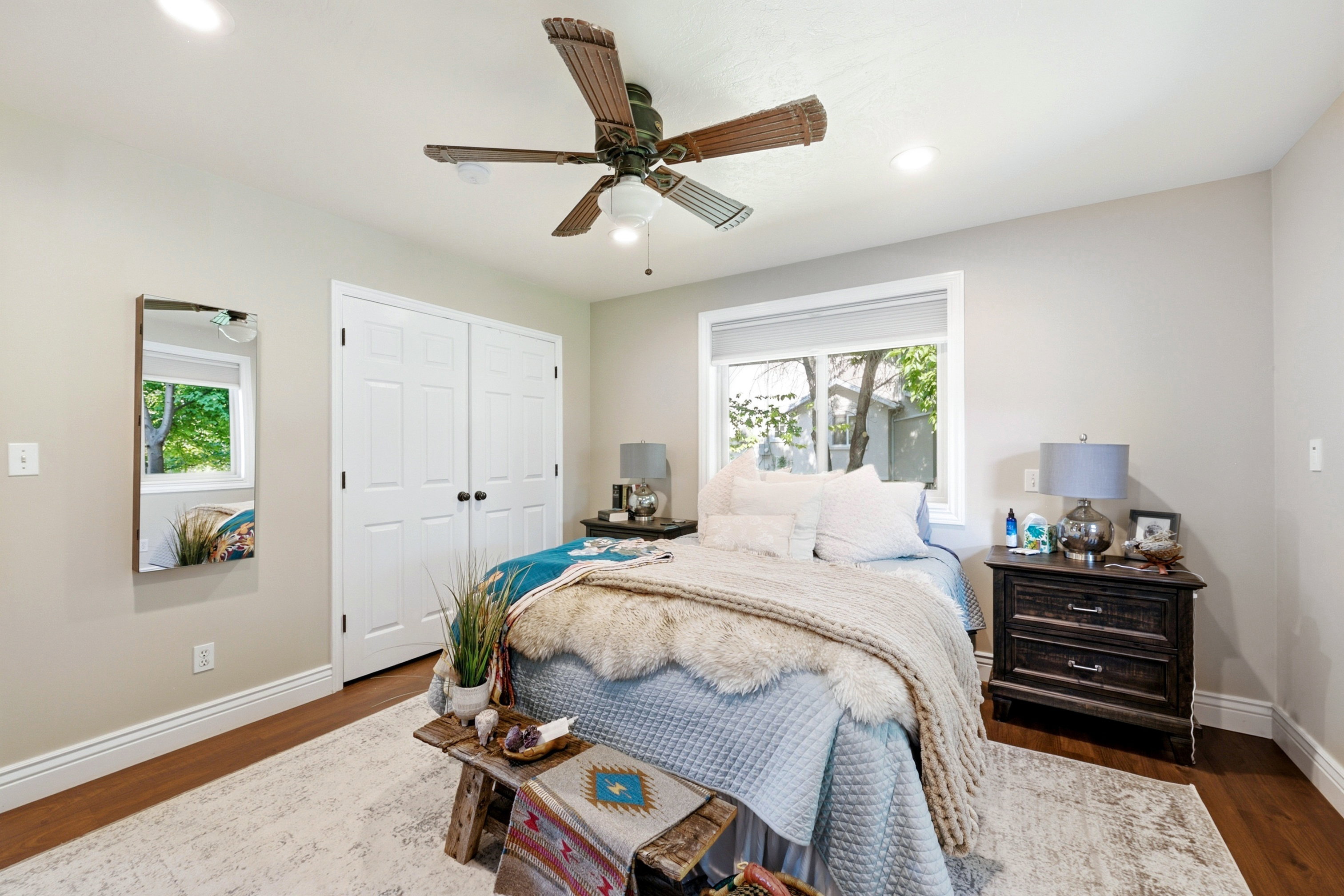 Well-lit interior space featuring wood-finish flooring and a ceiling fan