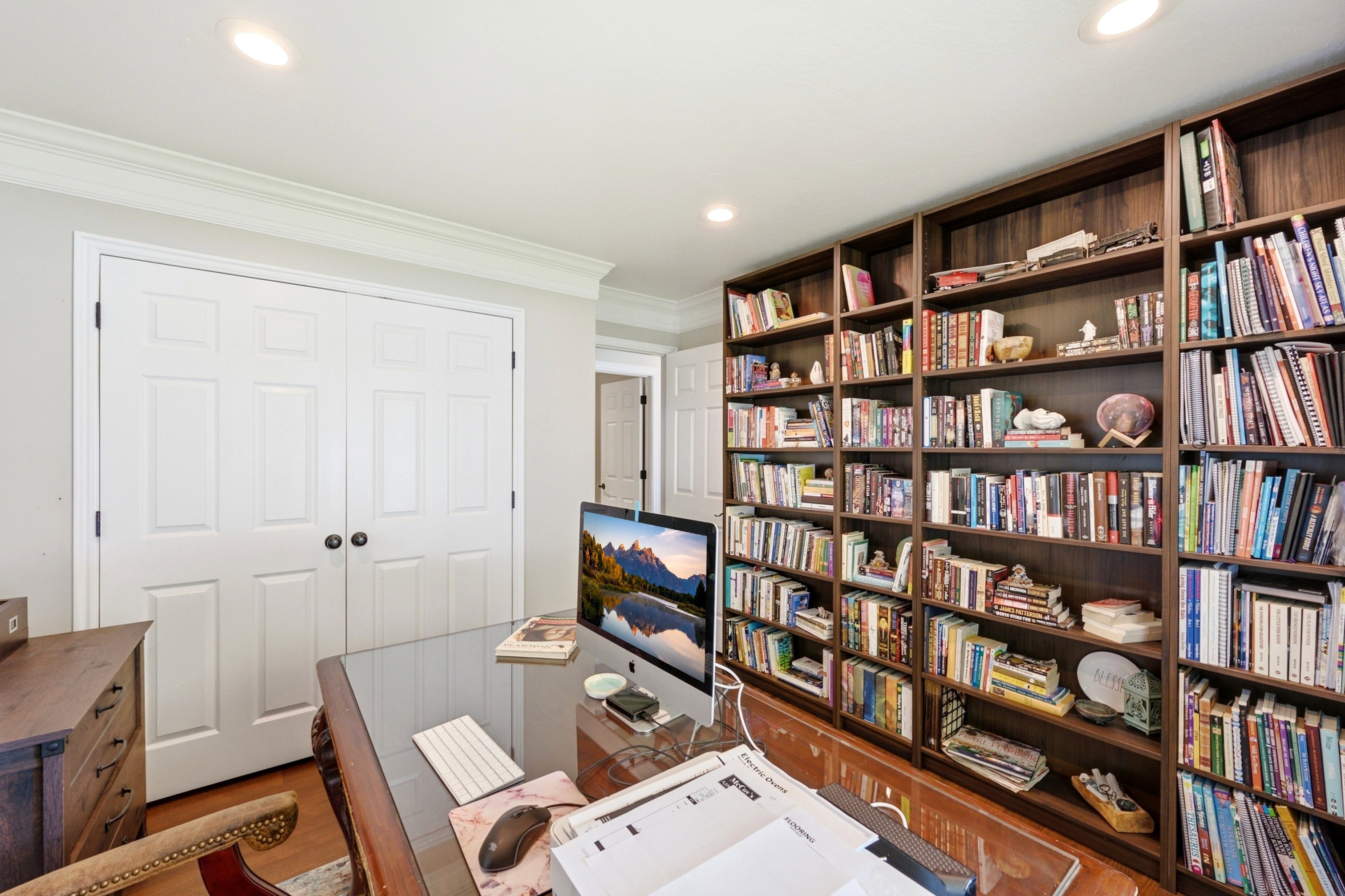 Room featuring built-in wood bookcases and recessed ceiling lighting