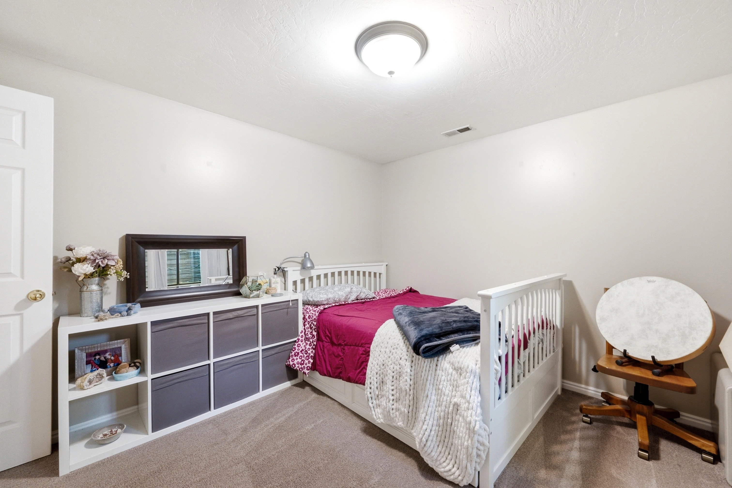 Light-colored walls complement neutral carpeting
