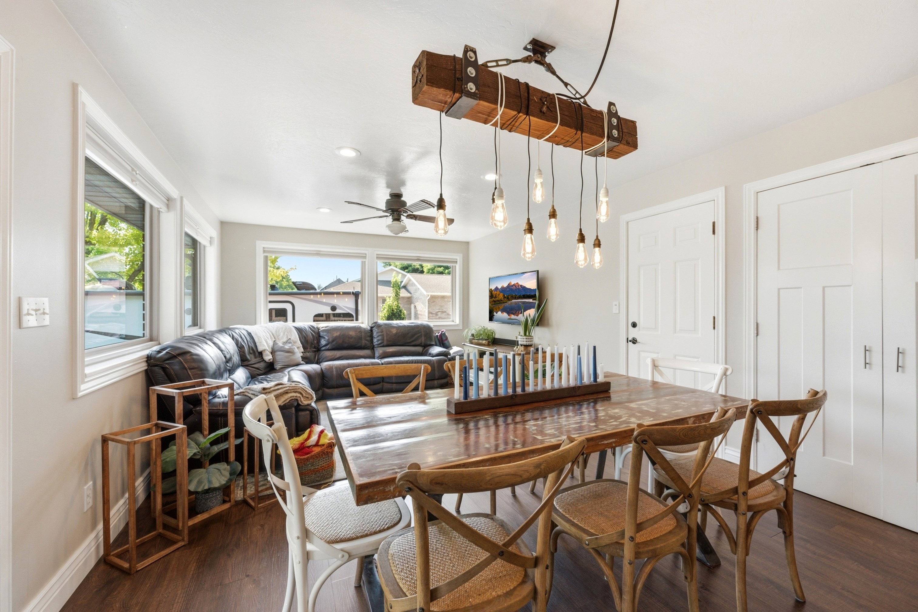 Open-concept living area featuring dark wood-finish flooring, white trim, and light gray wall color