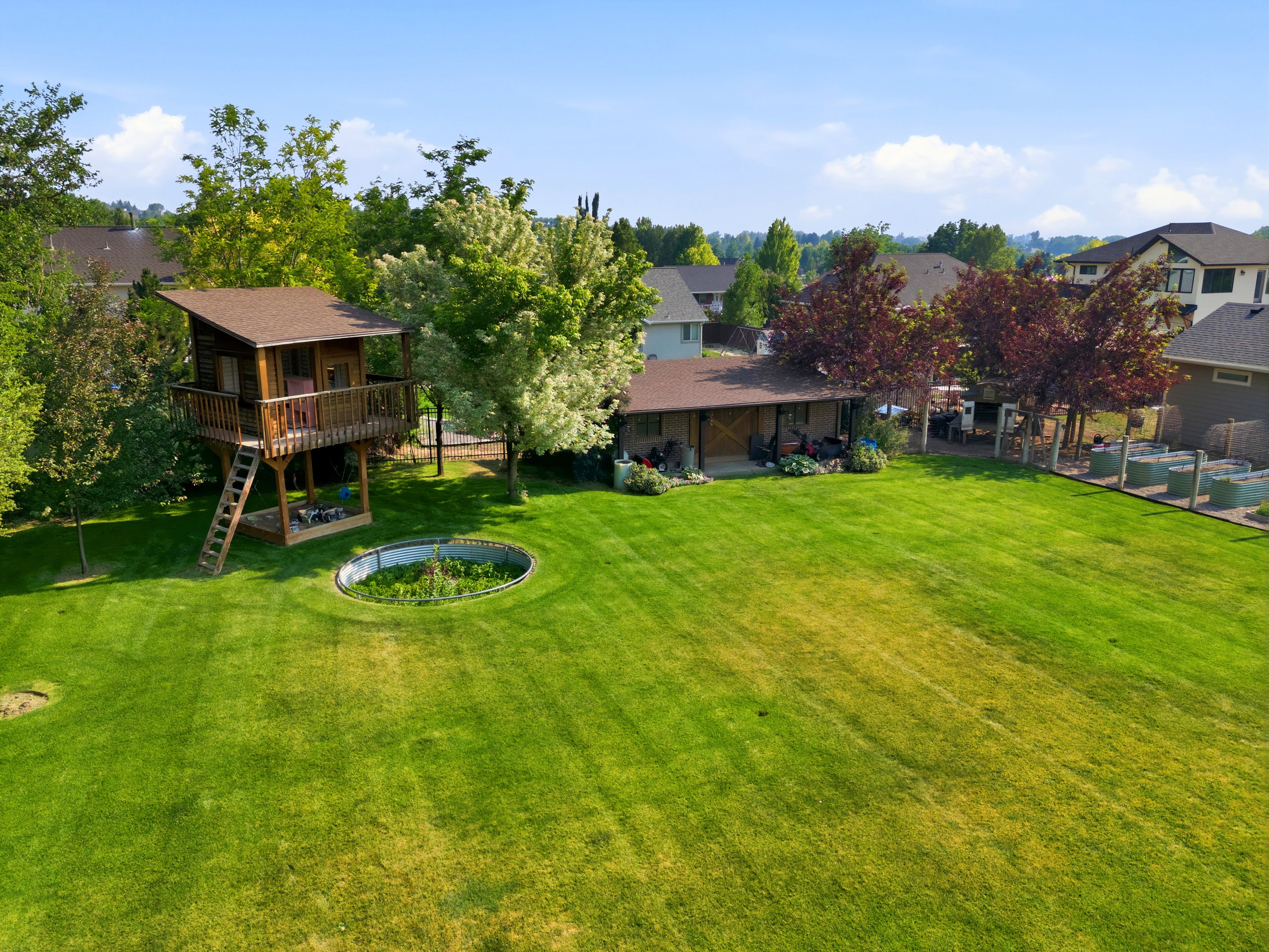Expansive green lawn featuring a built-in circular planter