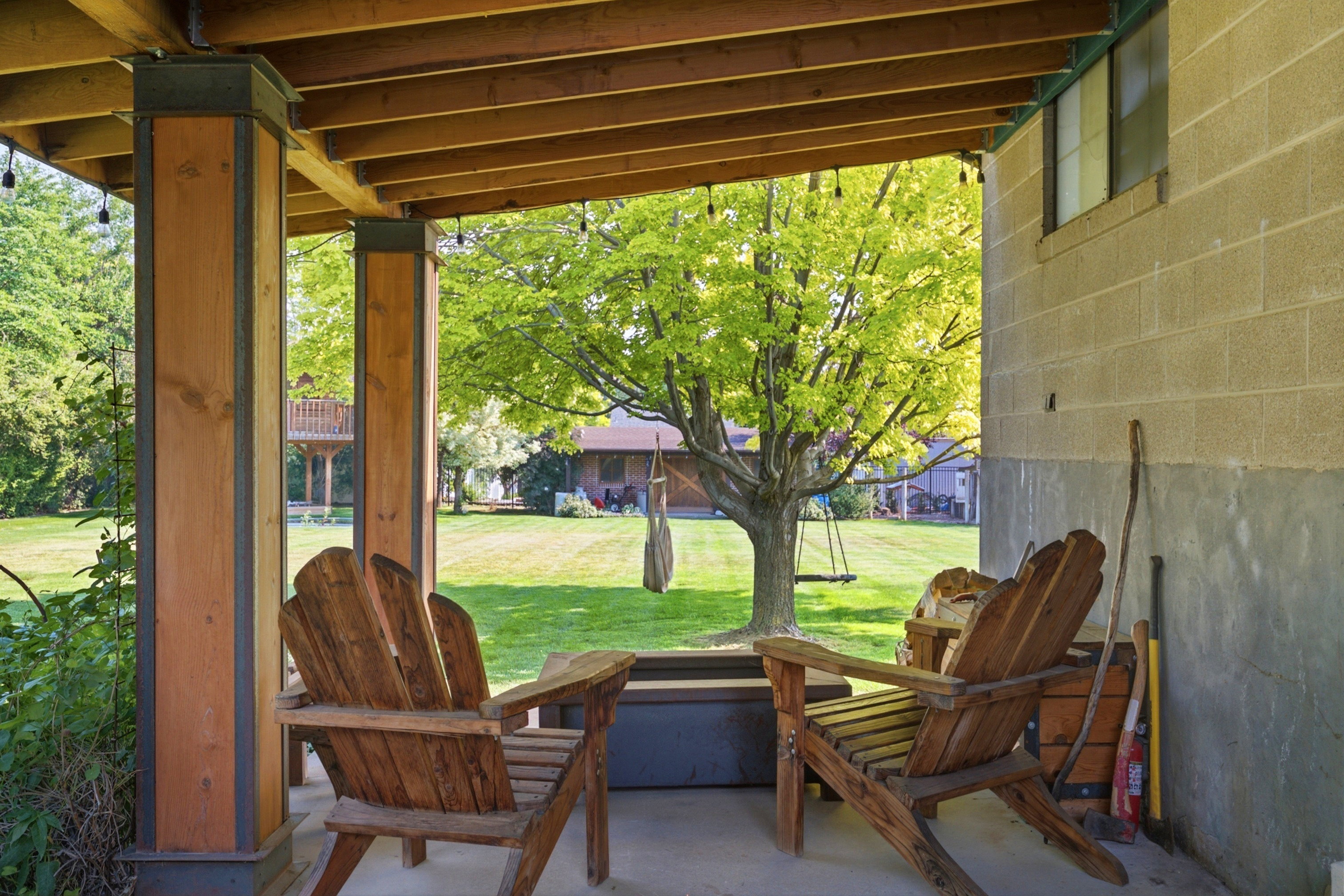 Covered patio with exposed wood joists and string lighting