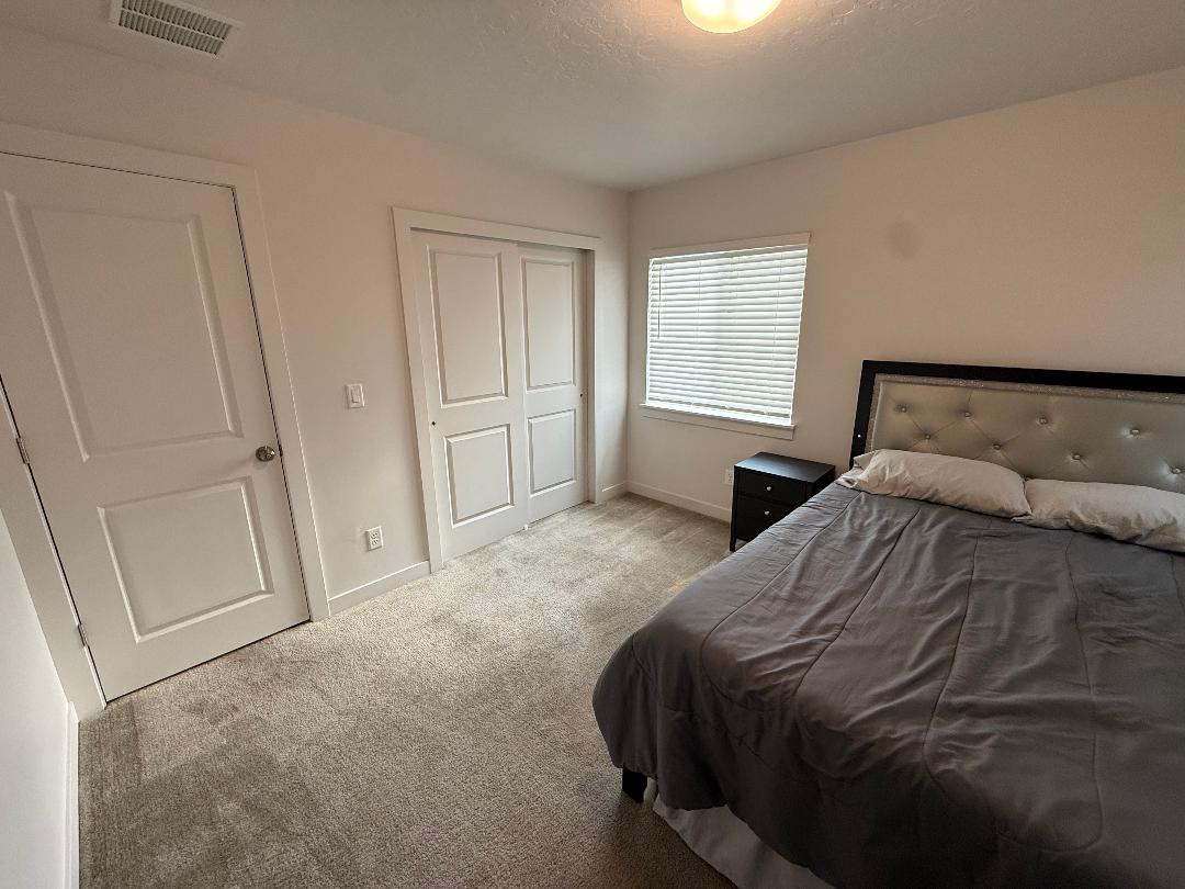 Light gray wall-to-wall carpeting complements the white walls and trim