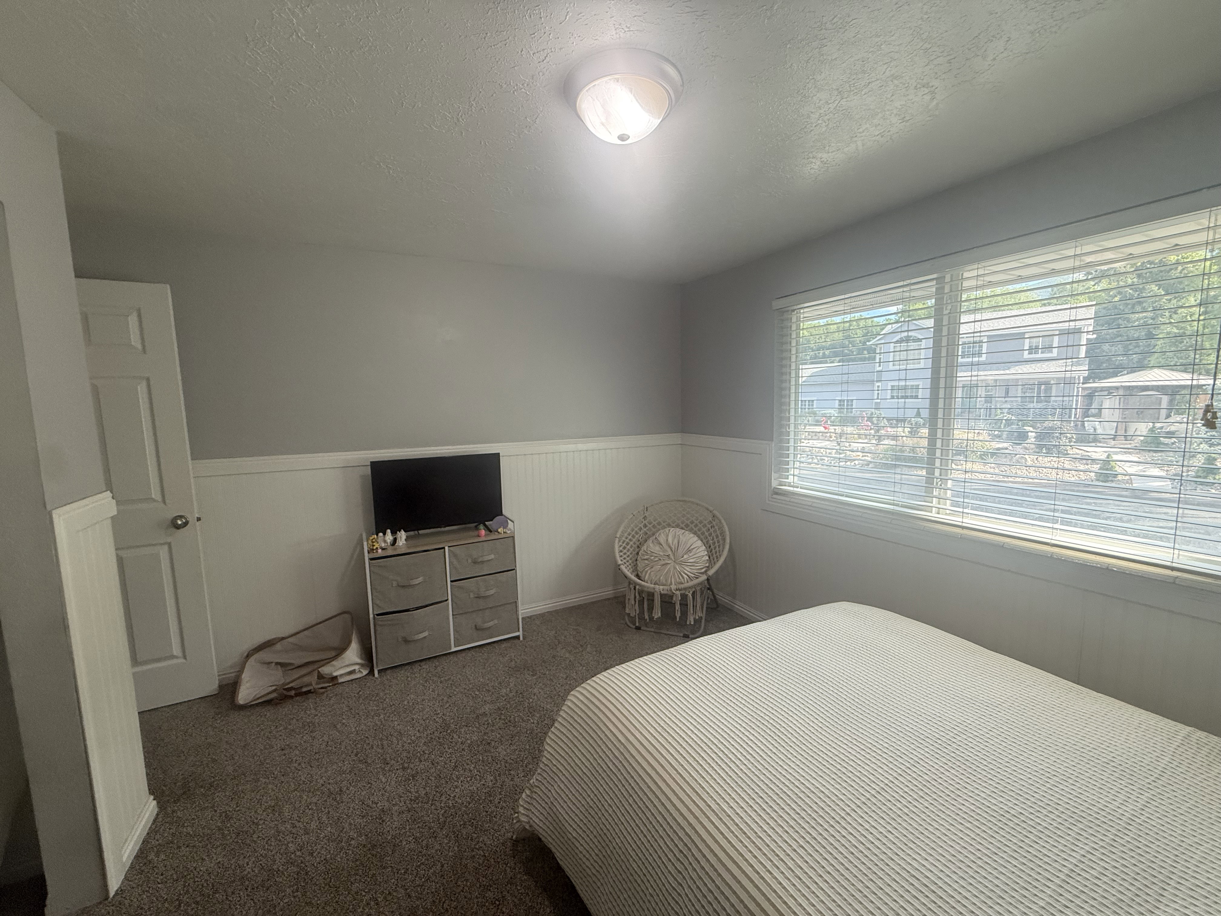 Wall-to-wall carpeting and neutral wall tones define this interior space