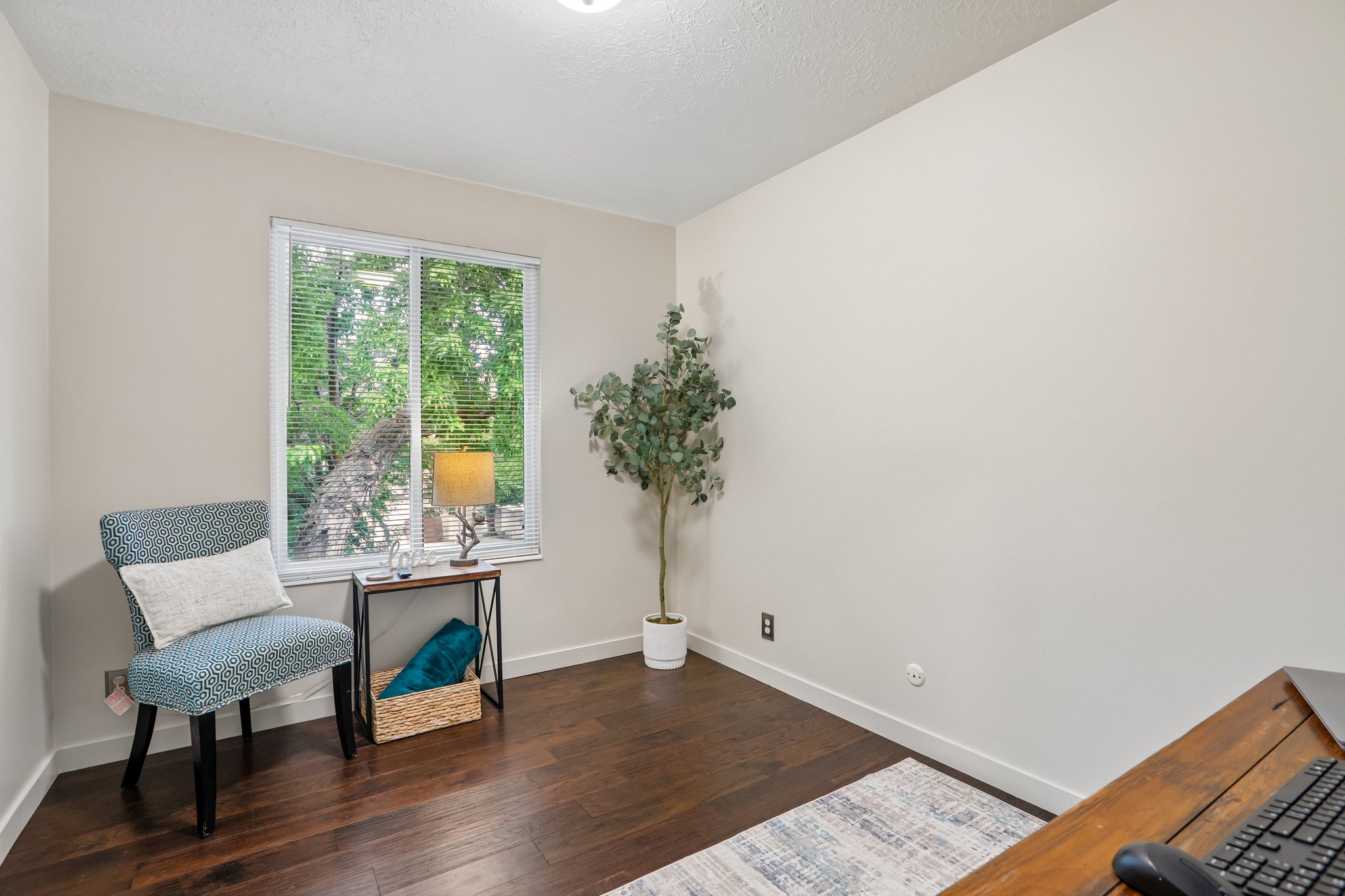 Bright interior room with wood-finish flooring