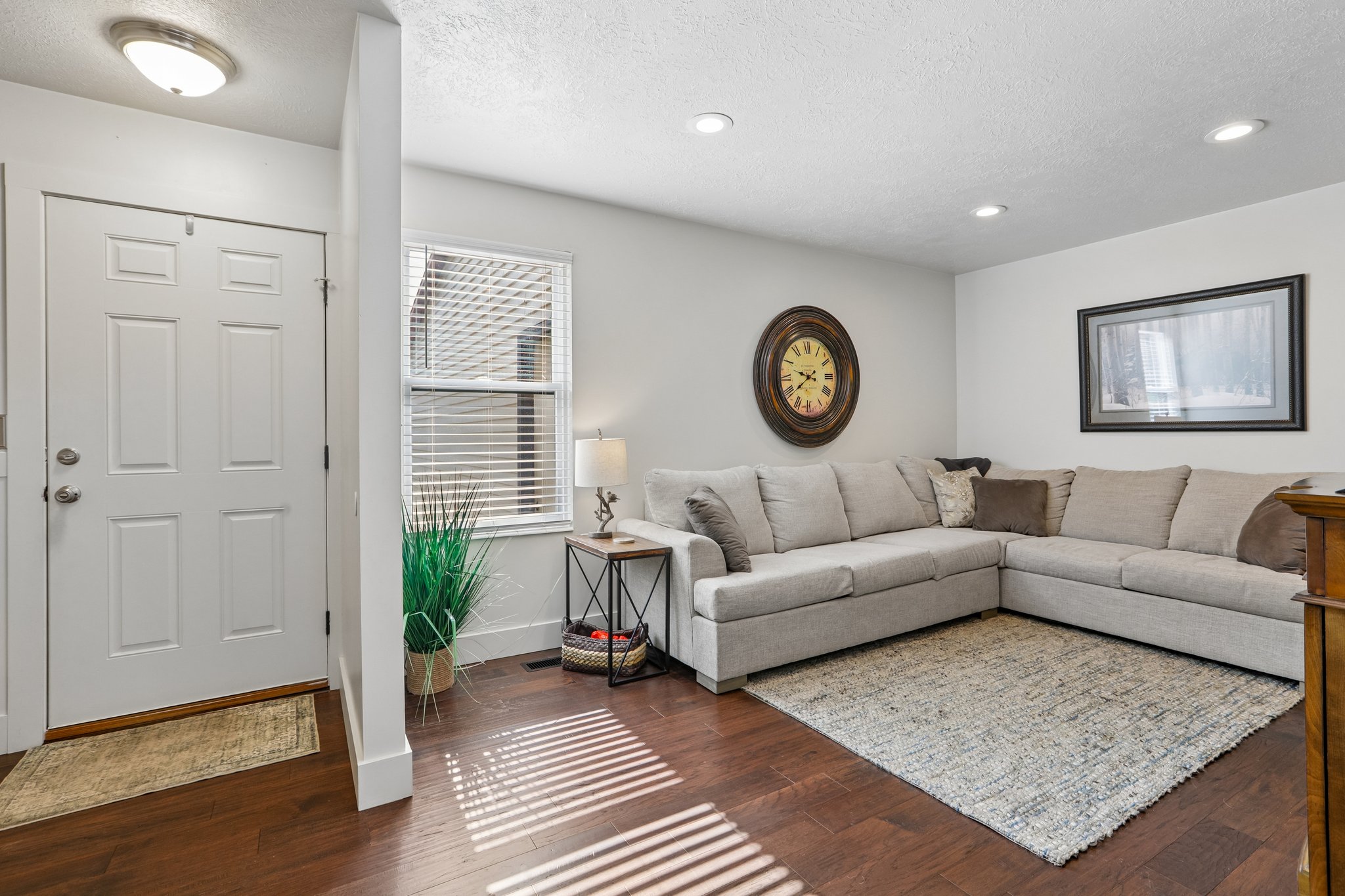Warm-toned wood-finish flooring extends throughout this space