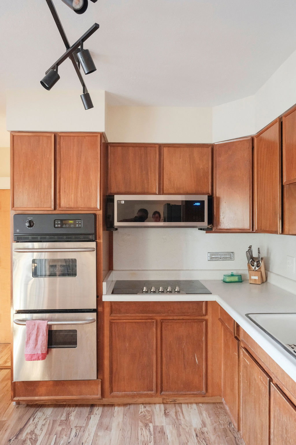 Kitchen featuring wood-finish cabinetry, stainless steel double wall oven, and built-in microwave