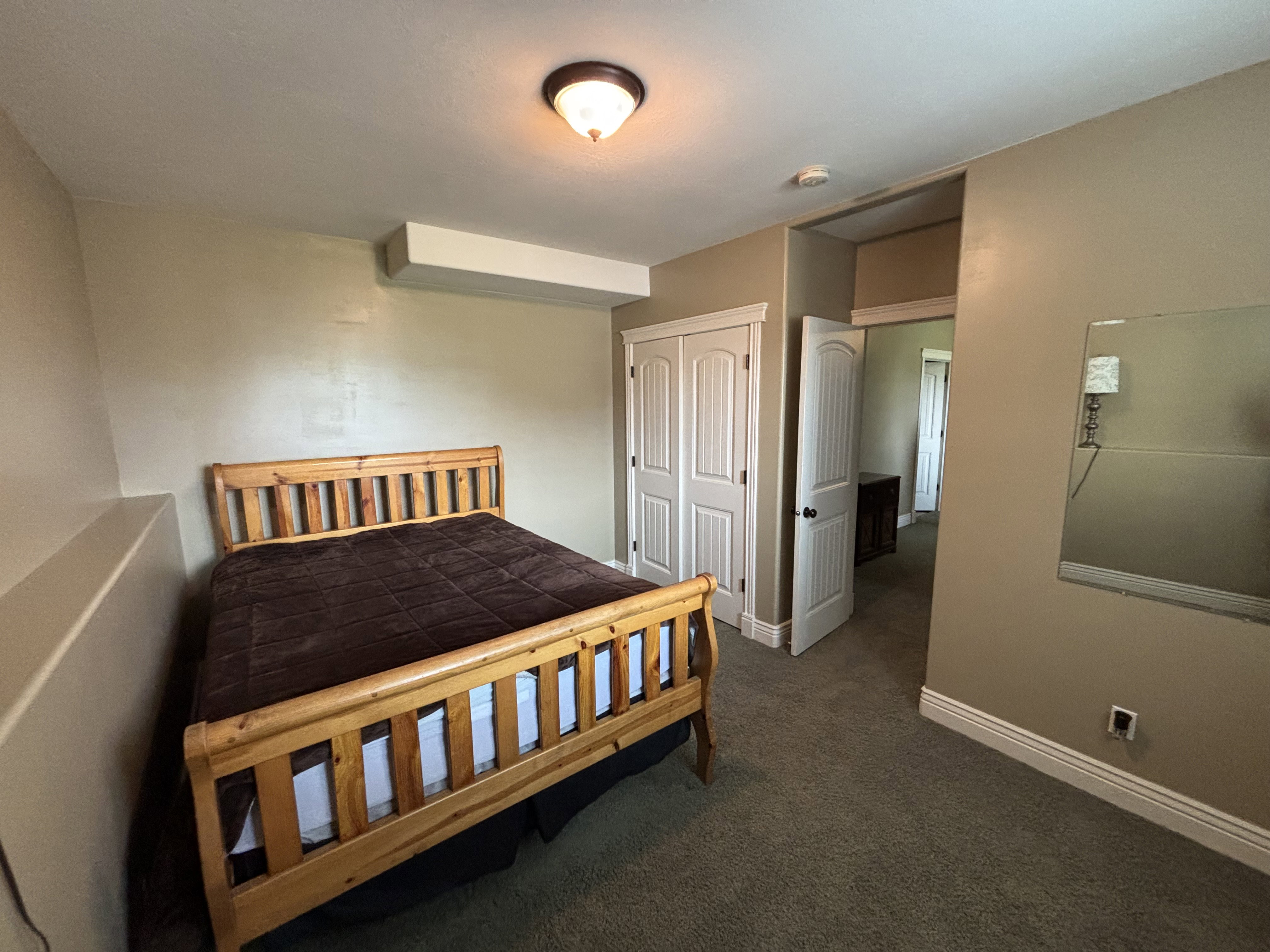Carpeted room featuring a ceiling-mounted light fixture, neutral wall finishes, and white baseboards
