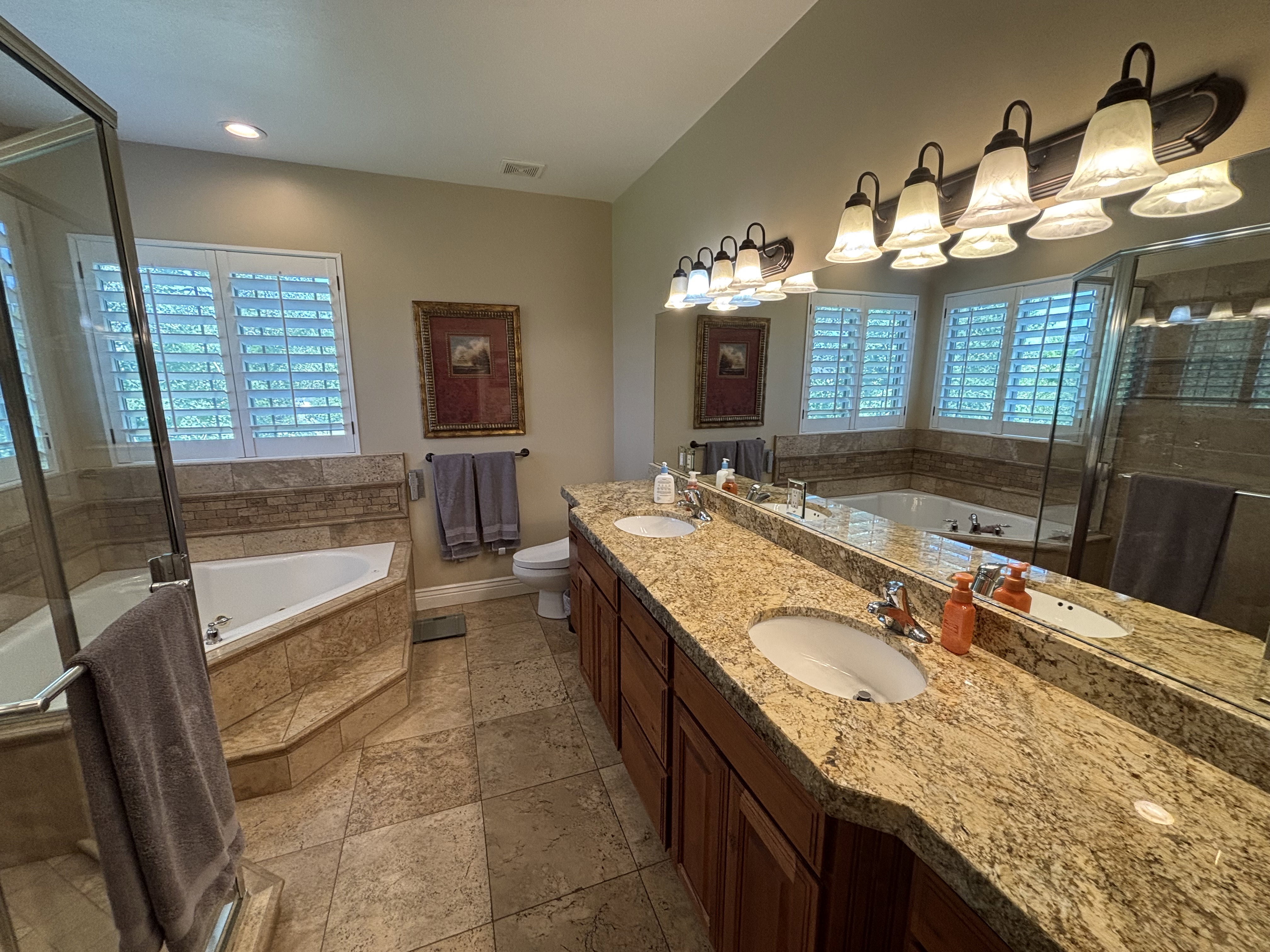 Expansive vanity featuring dual undermount sinks and a stone-finish countertop