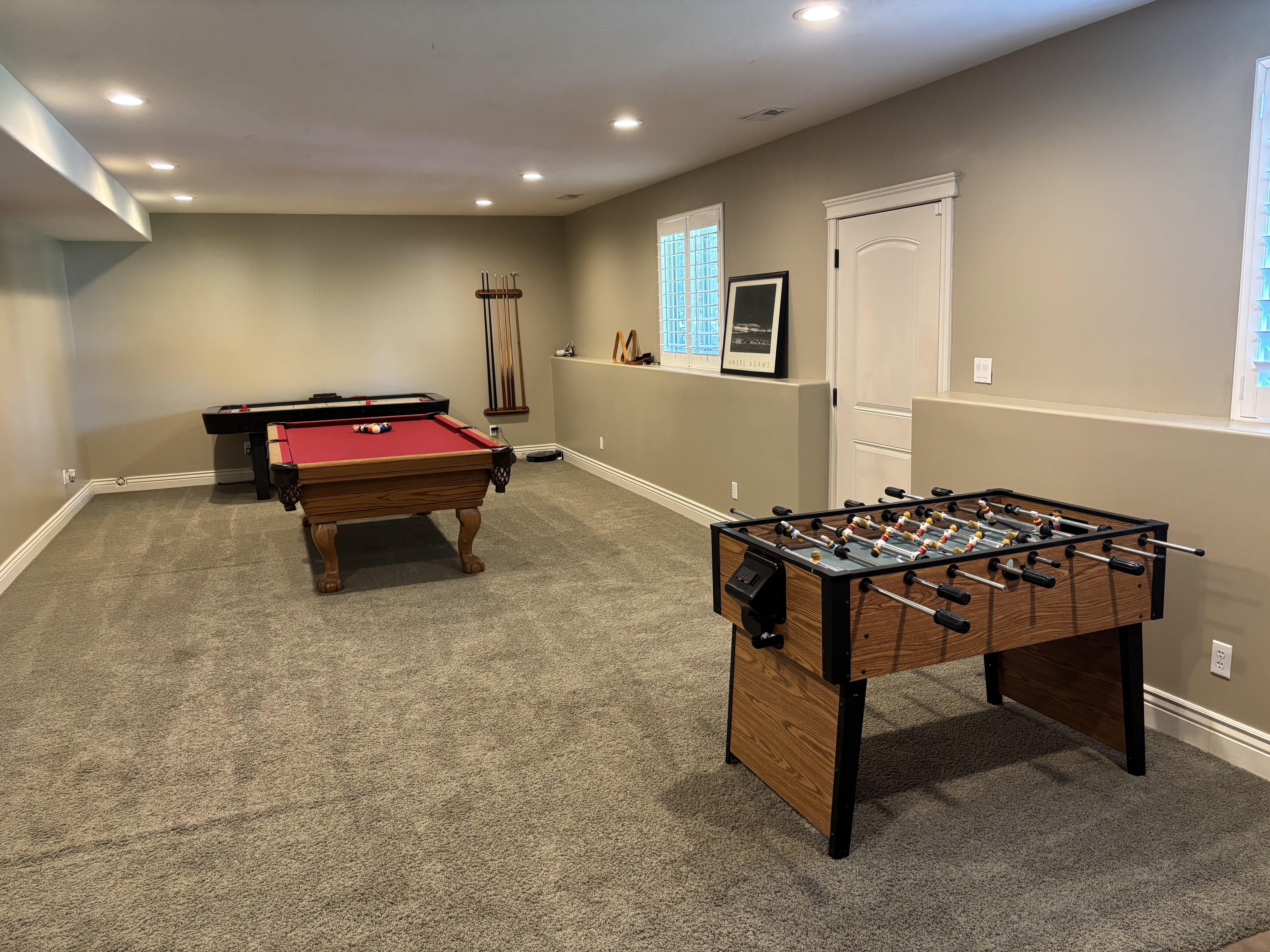 Finished basement featuring recessed lighting, a neutral color palette, carpeted flooring, and white trim
