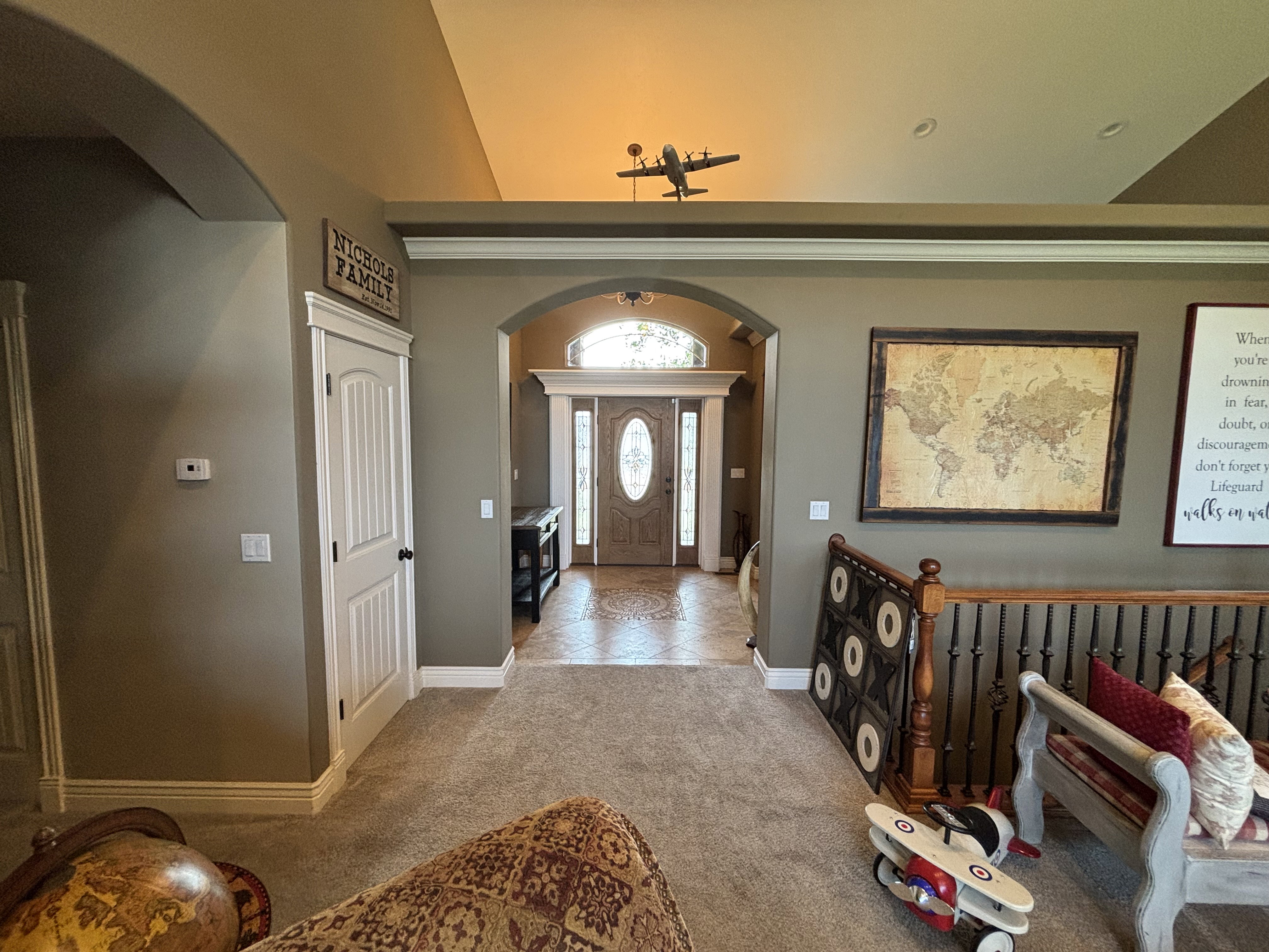 Arched entryway leading to a front door with decorative glass inserts