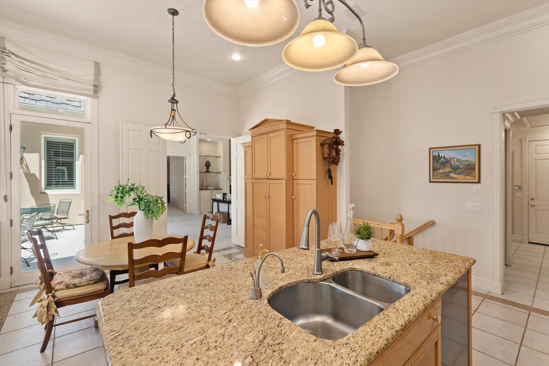 Kitchen island featuring a double basin stainless steel sink and a granite countertop