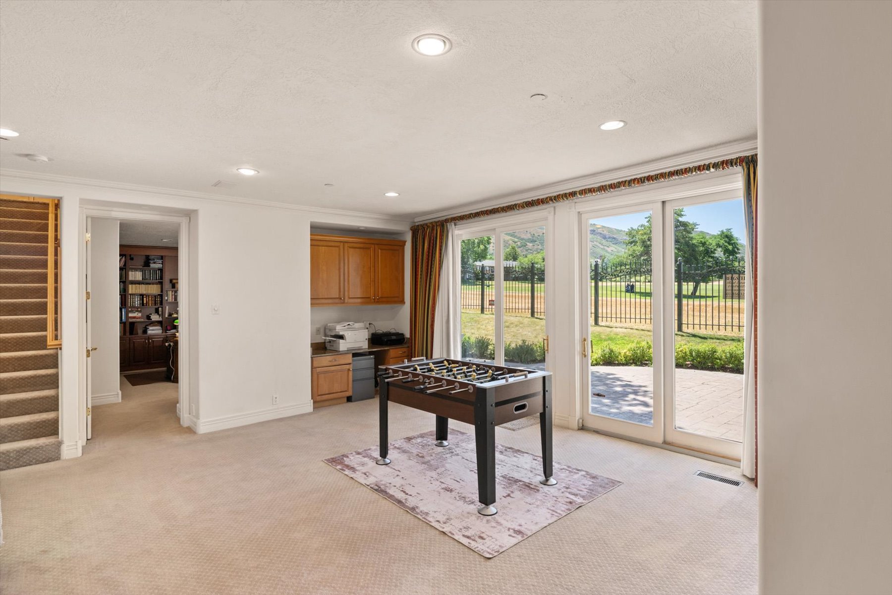 Carpeted room with recessed lighting and built-in cabinetry, walk out basement with lovely patio looking out on Bonneville Golf Course