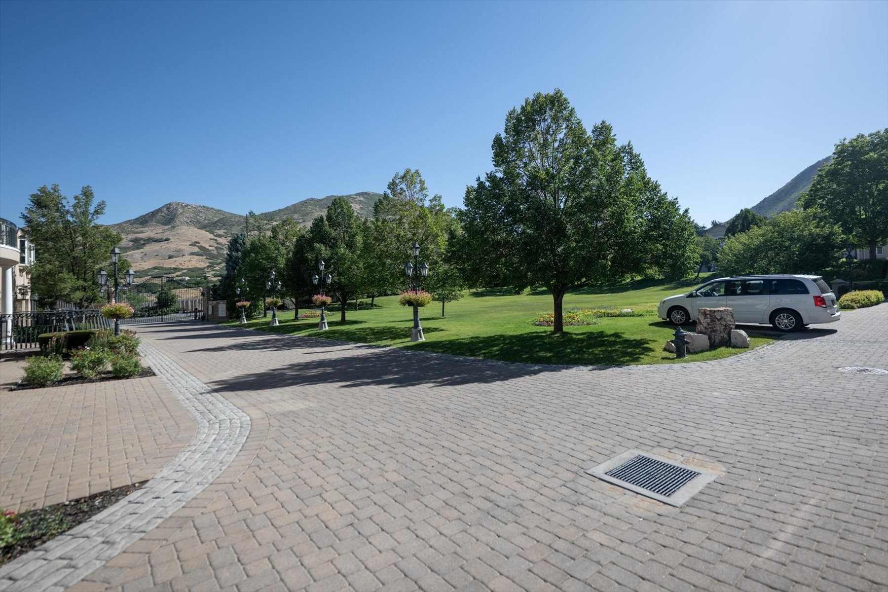 Brick paver driveway with a curved stone accent strip