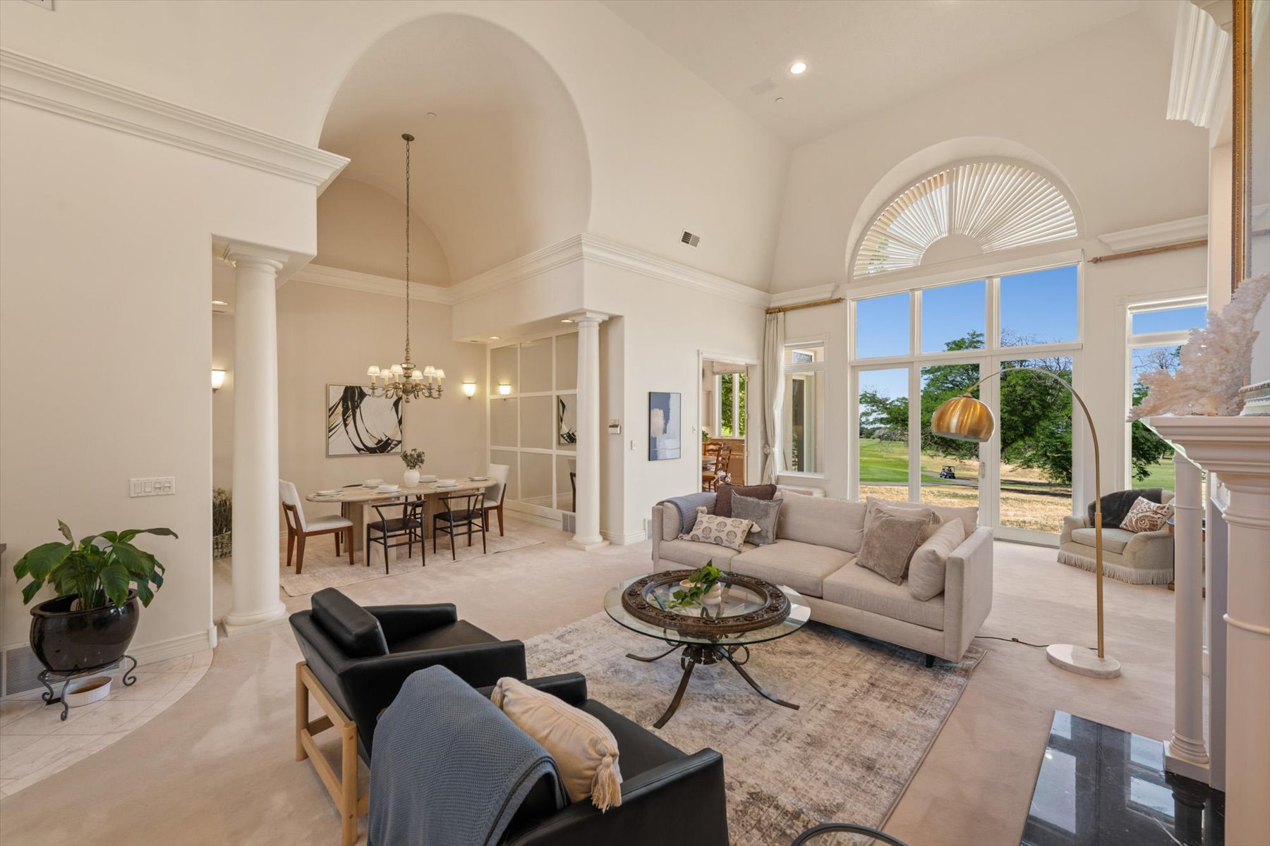 Living area with vaulted ceilings and large windows