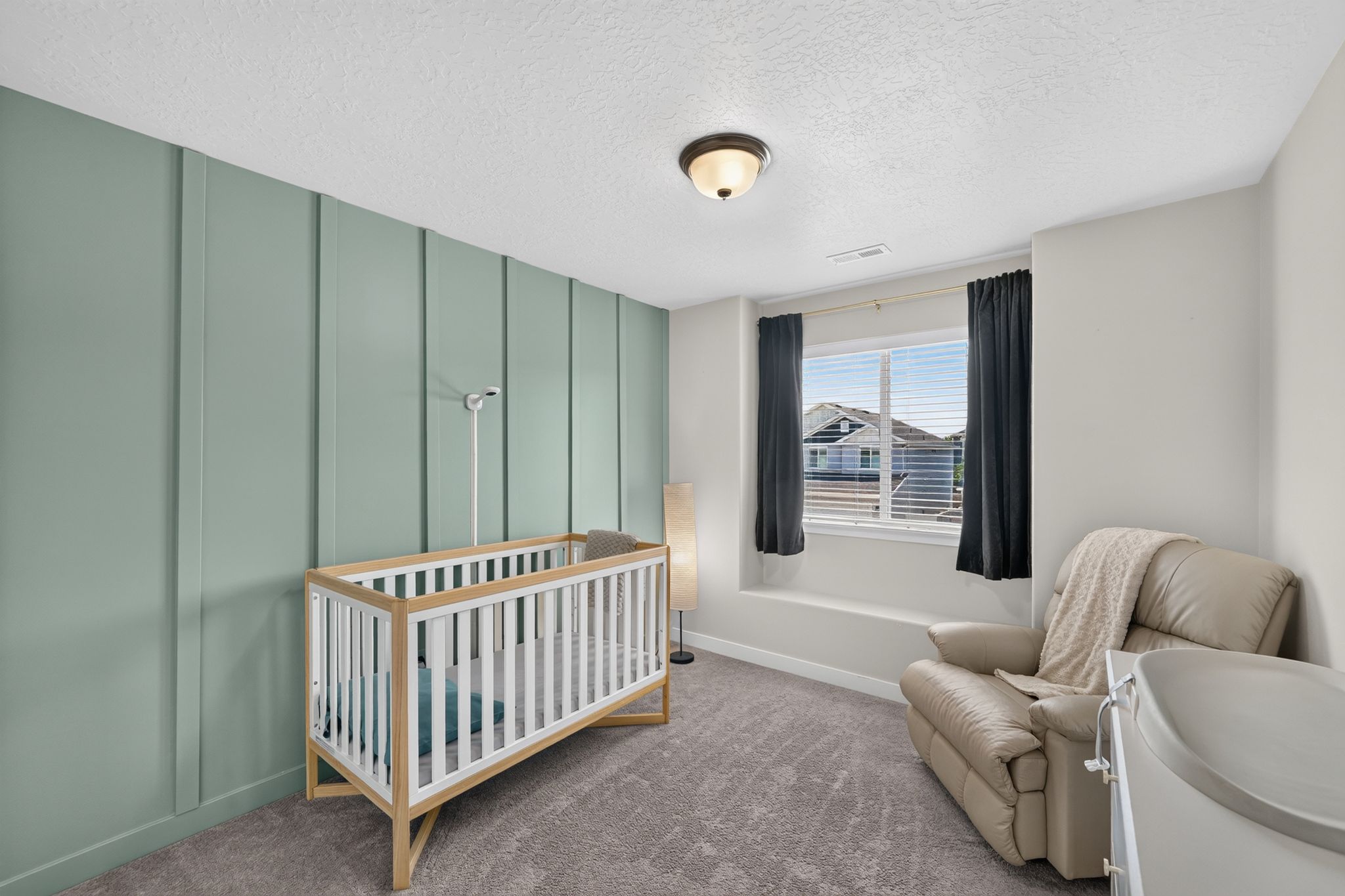 Room featuring a prominent accent wall with vertical paneling