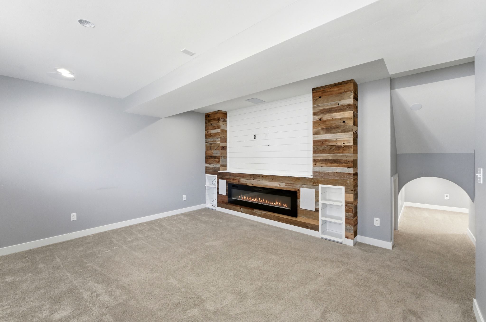 Reclaimed wood accent wall featuring a linear electric fireplace