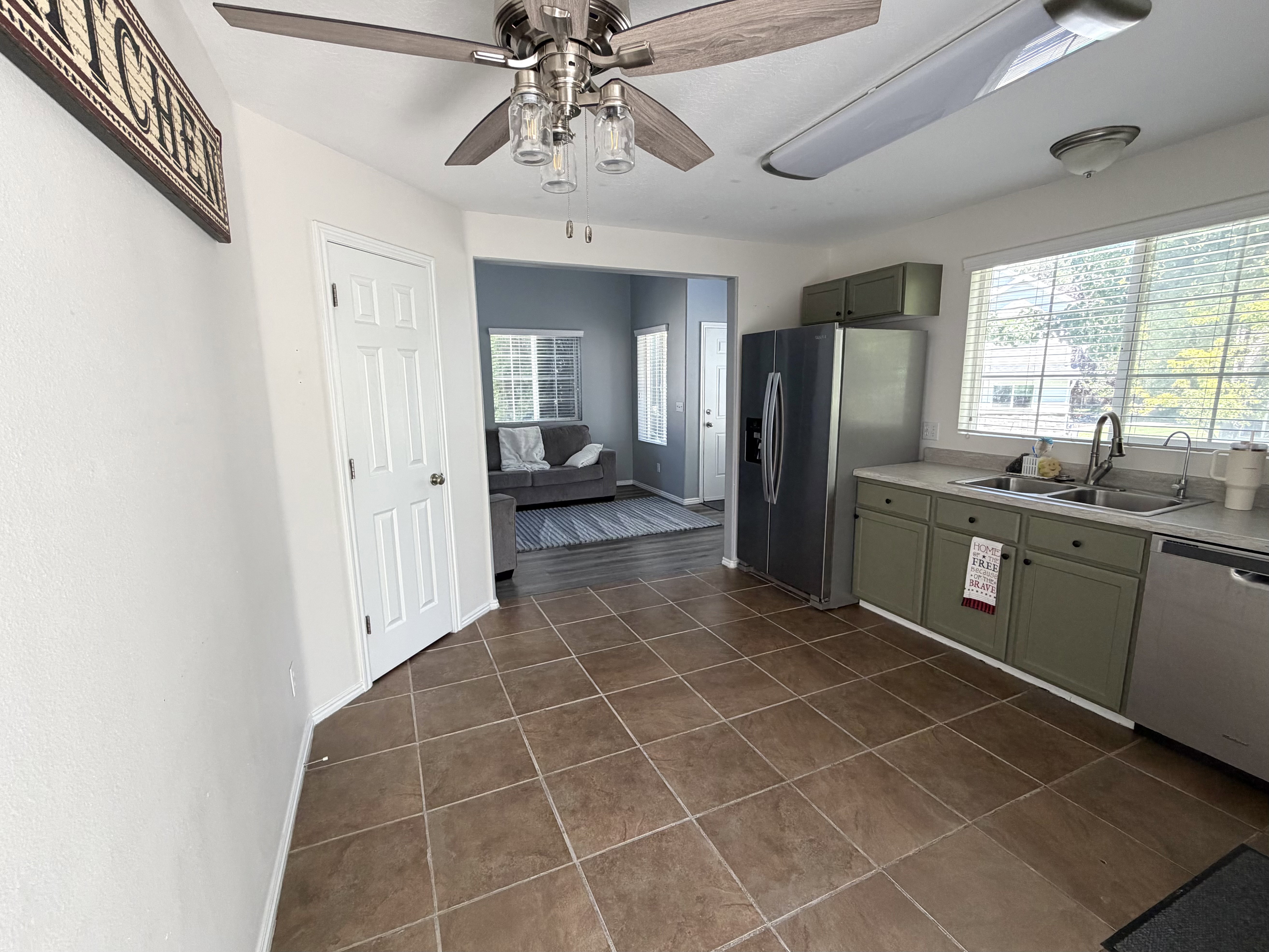 Kitchen featuring abundant natural light, recessed lighting, ceiling fan, tile flooring, and a stainless steel appliance suite