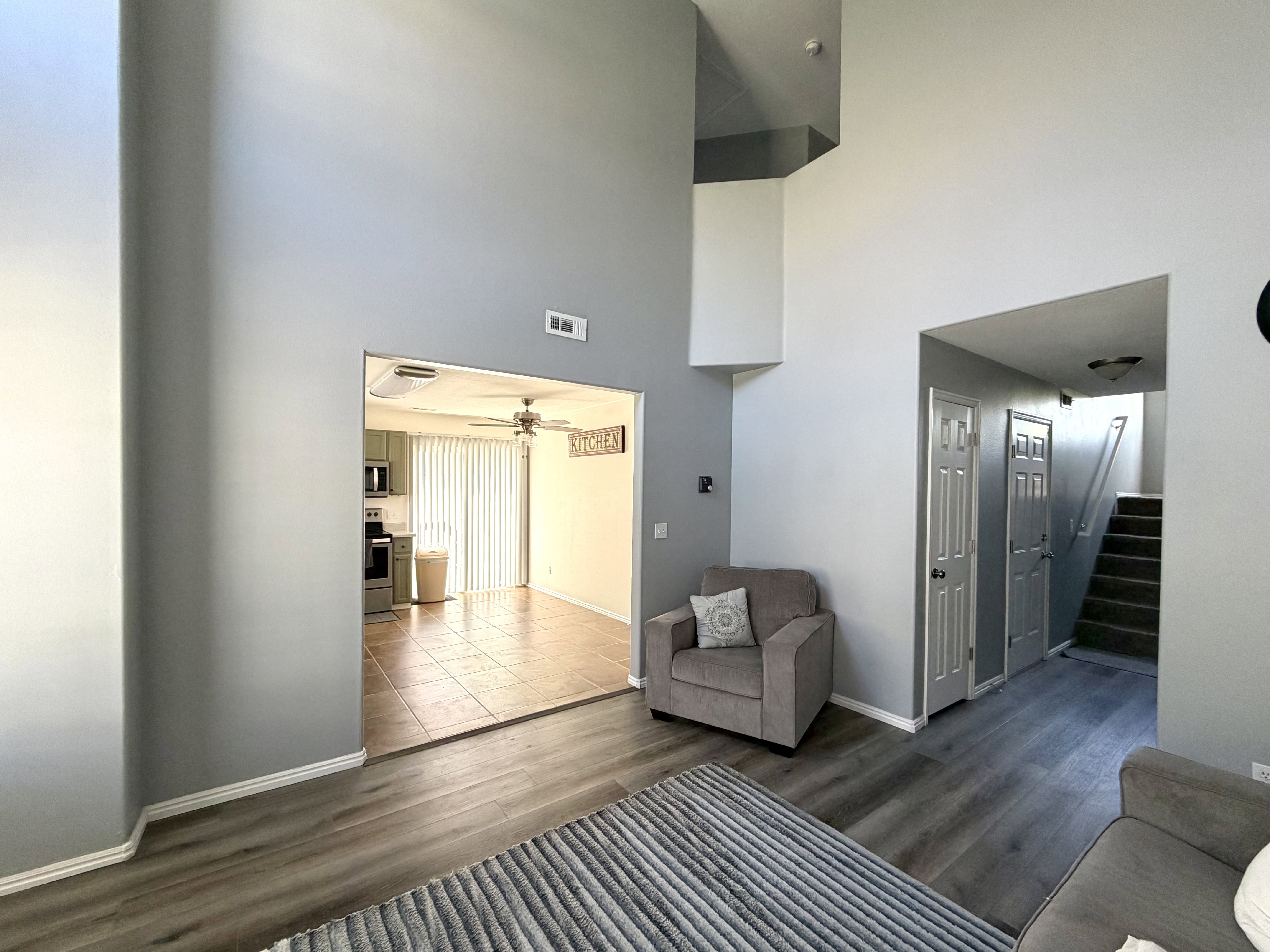Vaulted ceilings enhance the main living area featuring wood-finish flooring