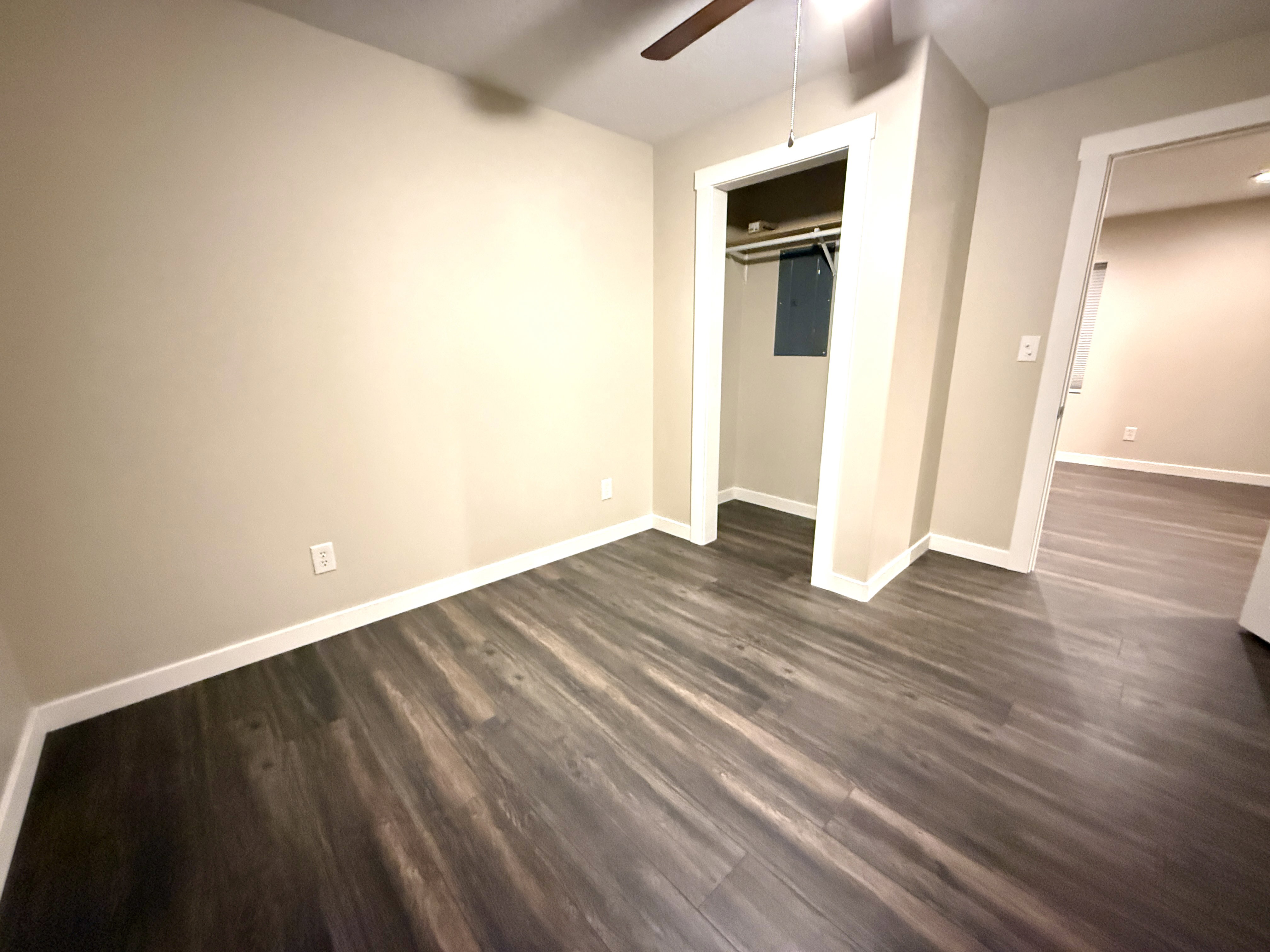 Neutral-toned interior featuring wood-finish flooring and white trim
