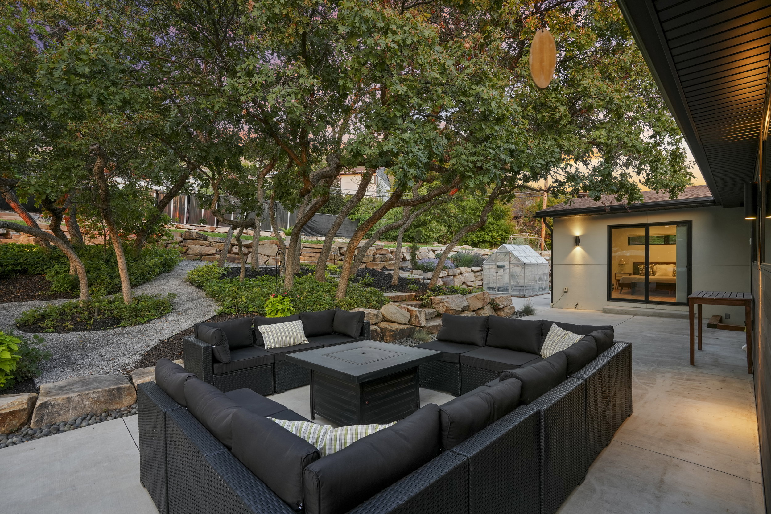 Expansive concrete patio area with integrated wall sconce lighting