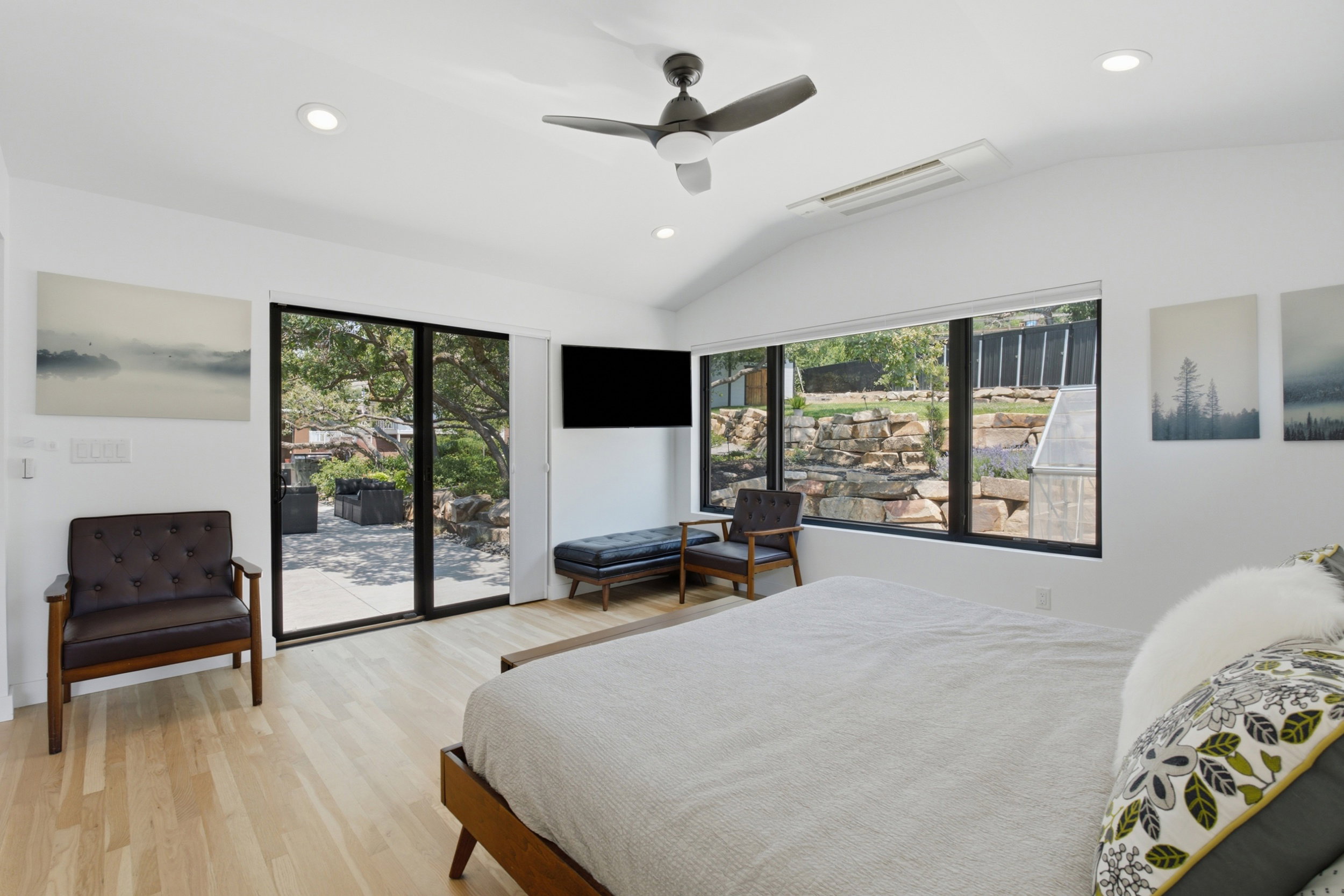 Vaulted ceilings with recessed lighting and a ceiling fan