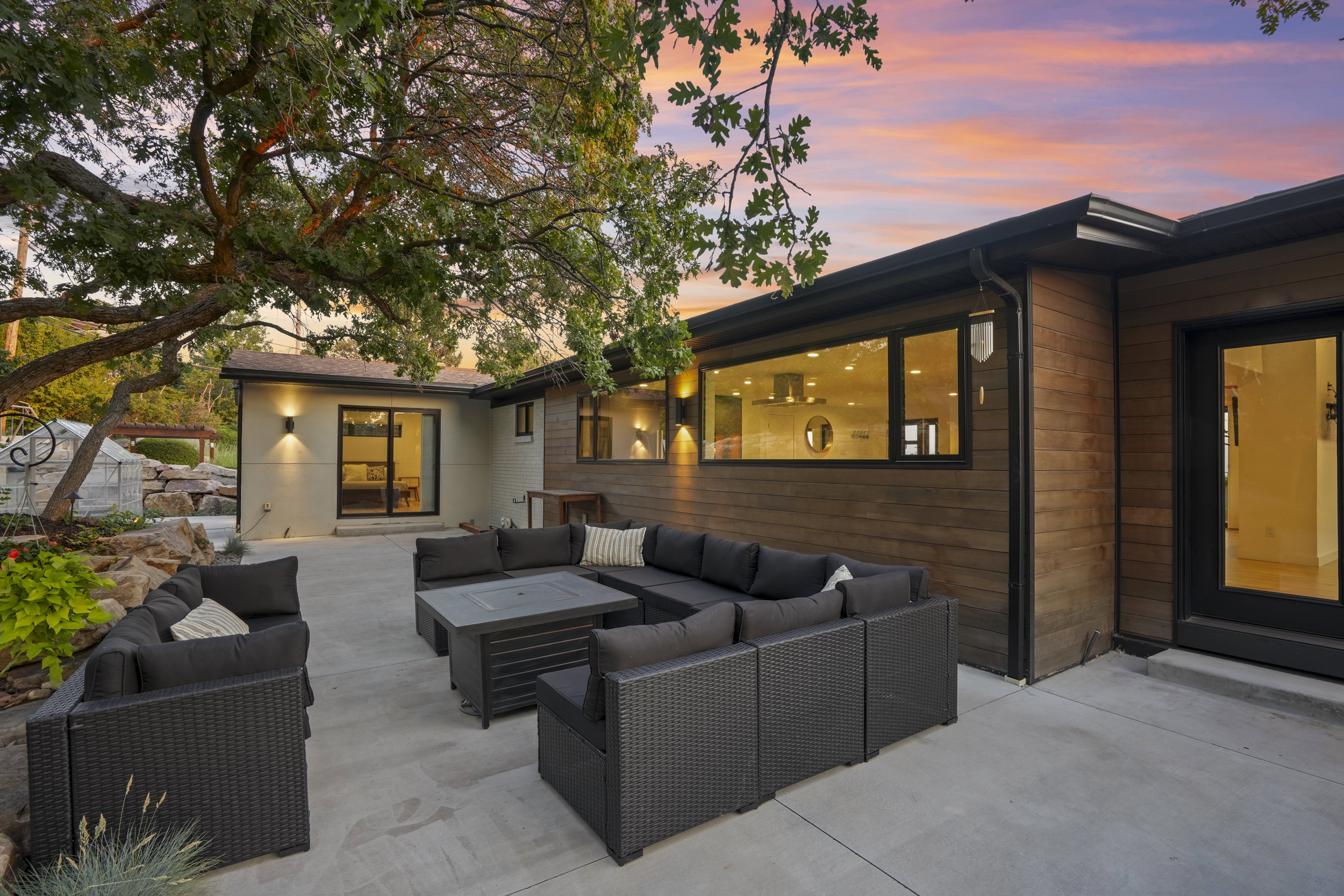 Expansive concrete patio area with multiple points of access to the residence