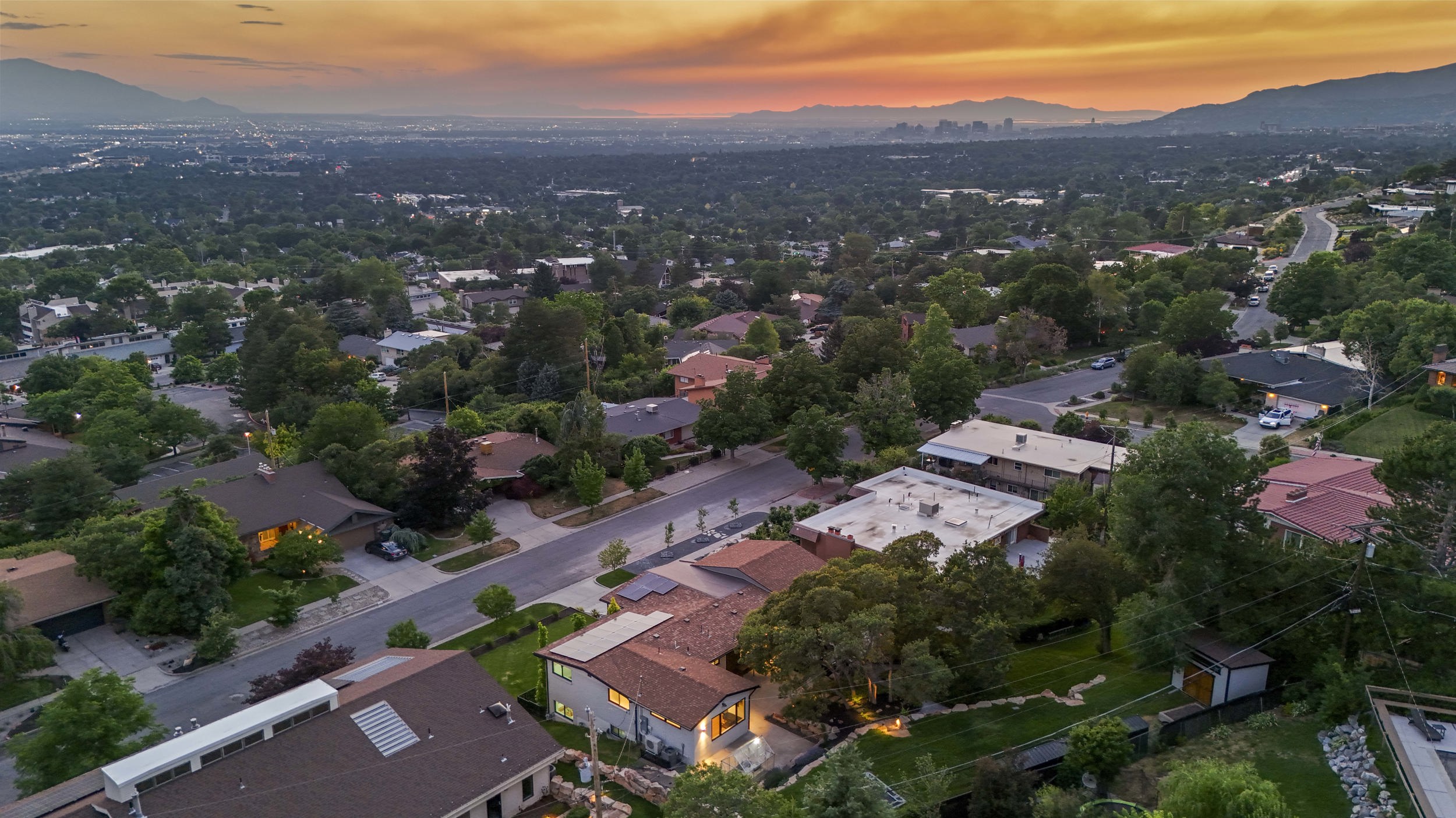 Aerial perspective showcasing a residential neighborhood with varied architecture and mature trees