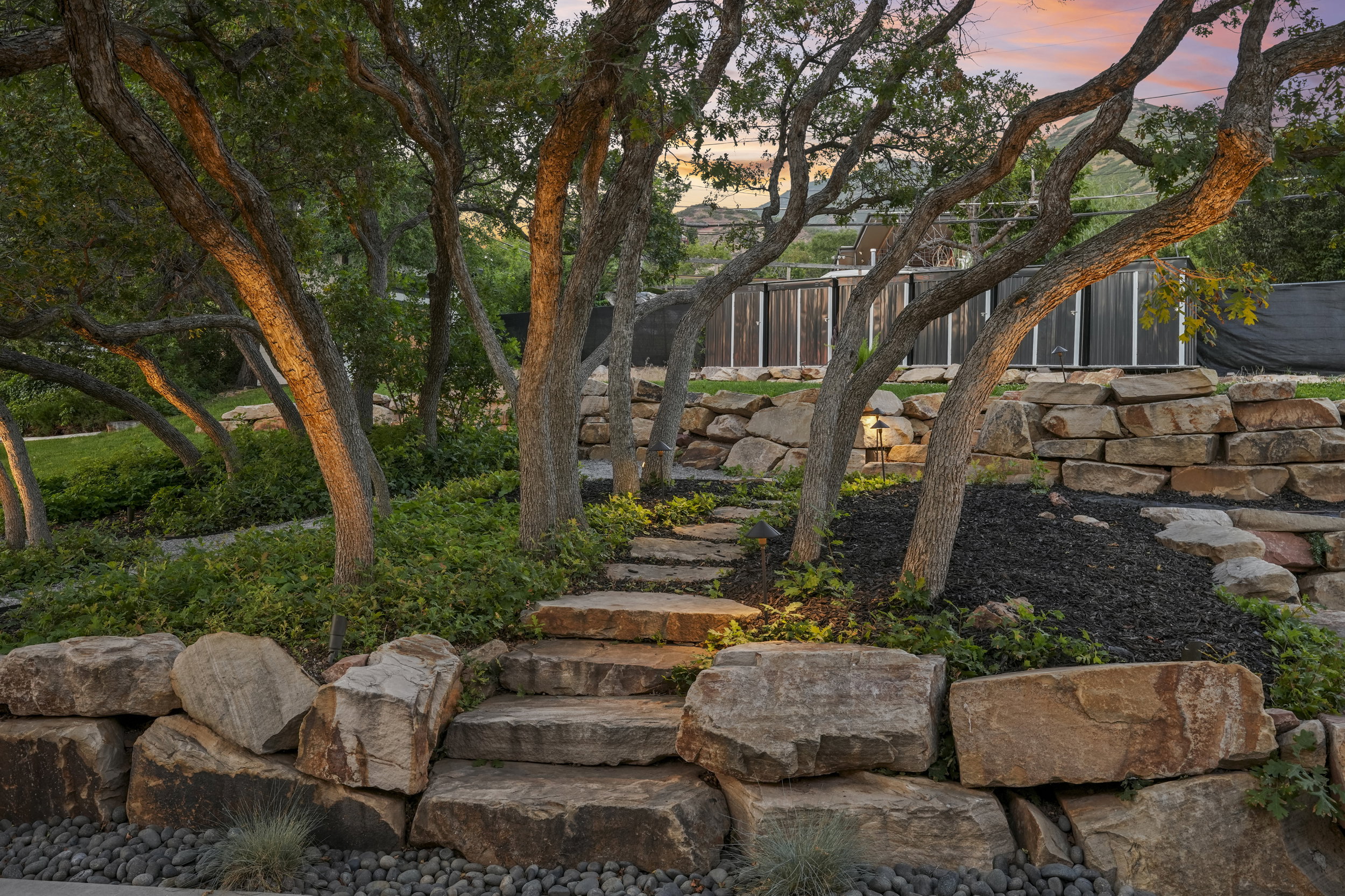 Tiered landscaping featuring natural stone retaining walls and steps