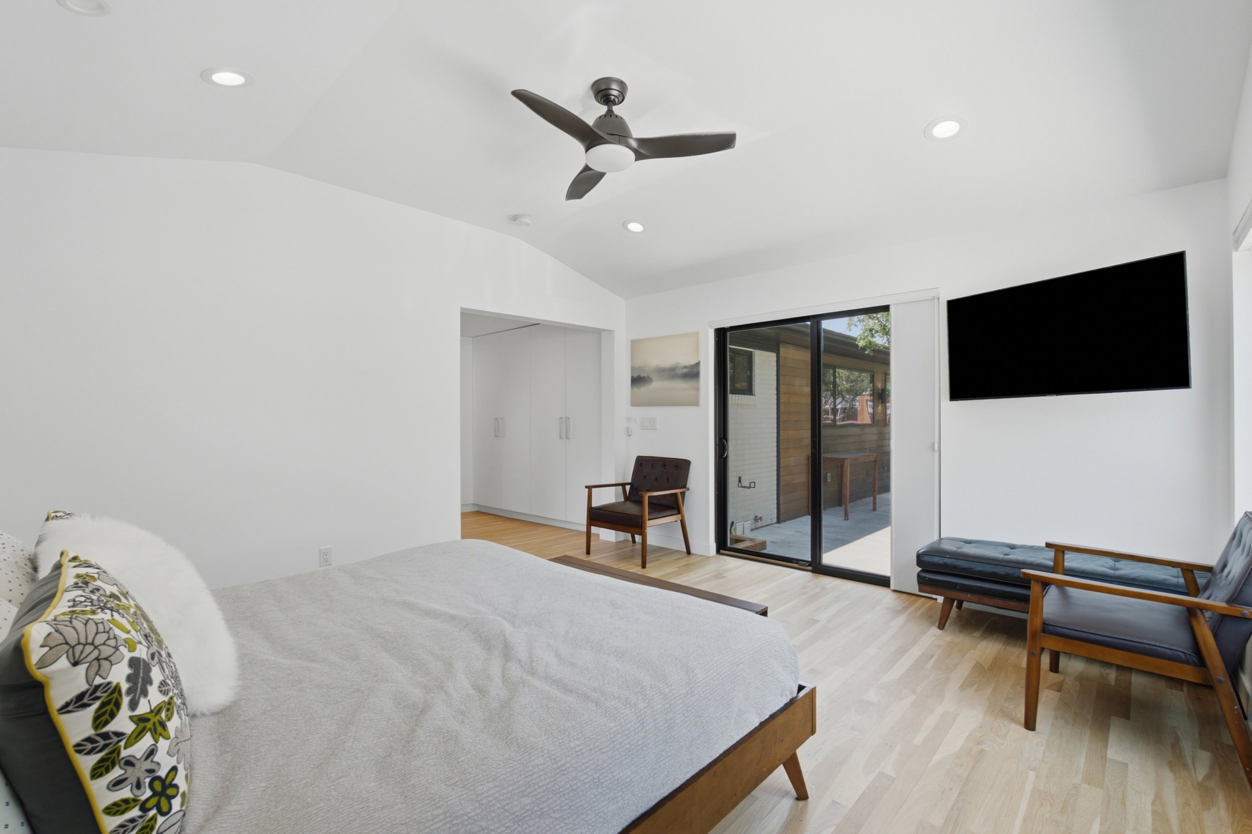 Vaulted white ceilings featuring recessed lighting and a ceiling fan